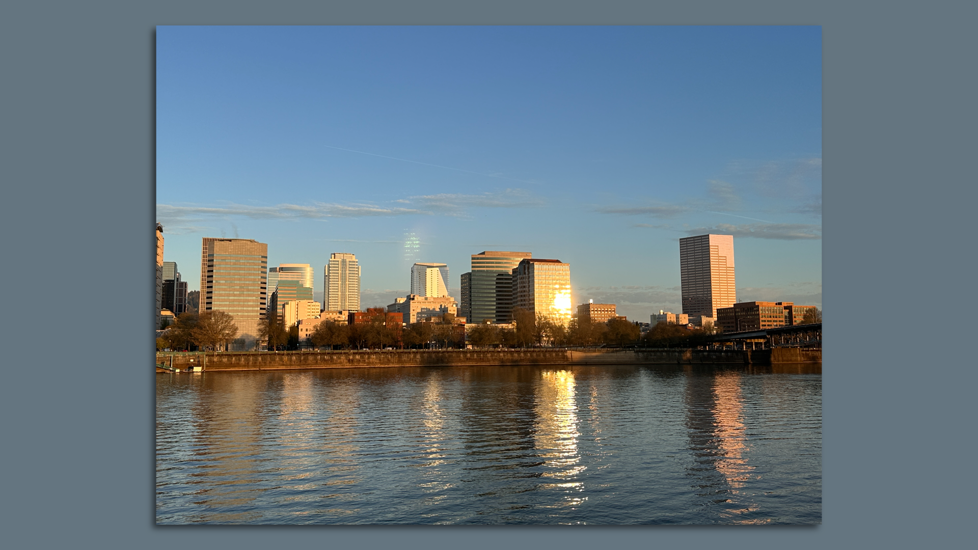 Portland Oregon skyline at dawn, offices in front of river