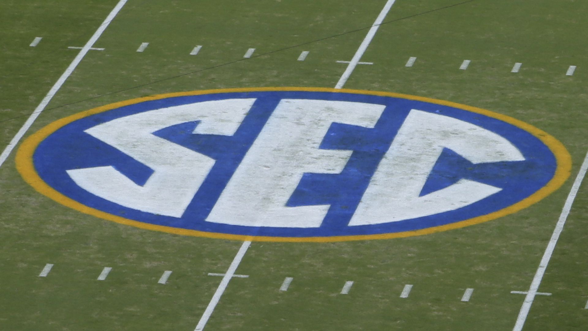 Picture of a football field with the Southeastern Conference logo
