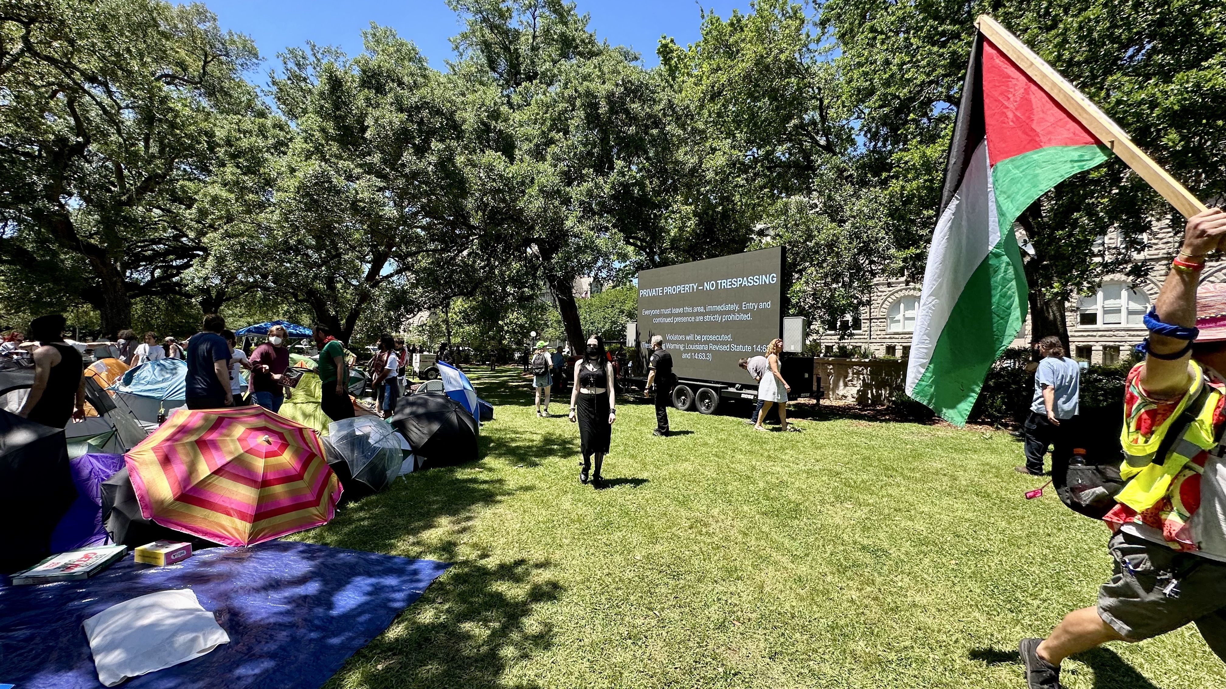 Photo shows protesters at Tulane with a Palestinian flag.