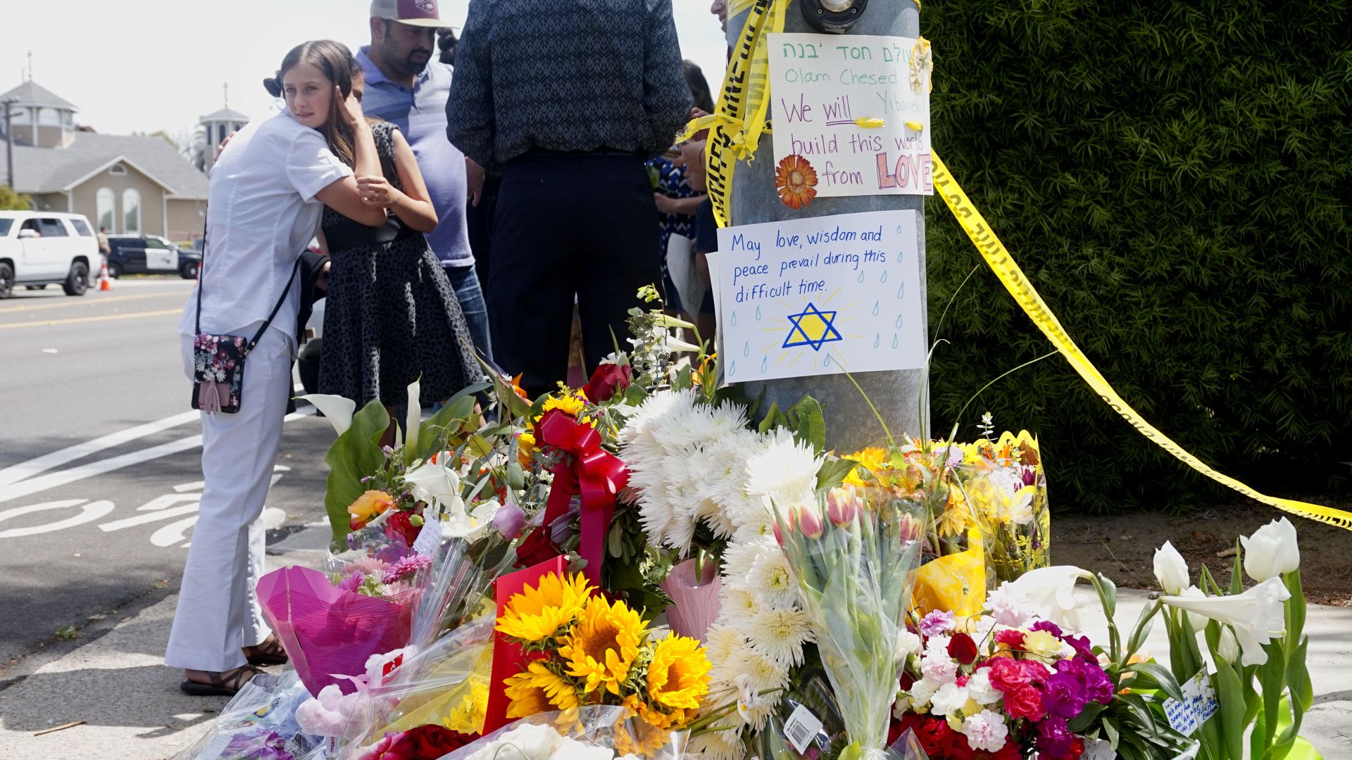 Mourners beside tributes at Chabad of Poway Synagogue in California.
