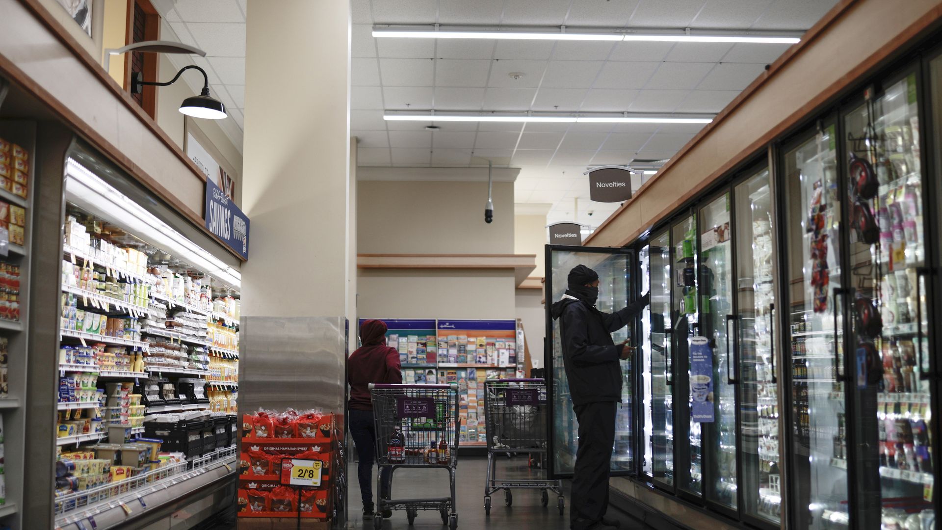 Shoppers at a Giant Foods in the aisles with carts