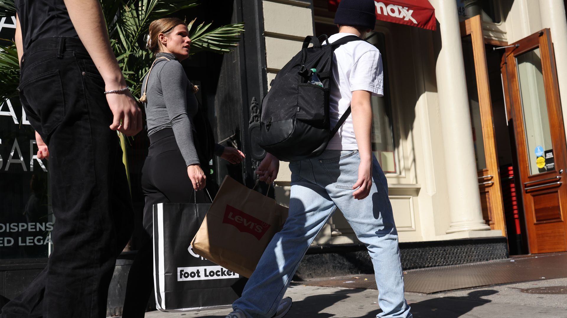 People carry shopping bags as they walk through SoHo on October 30, 2024 in New York City