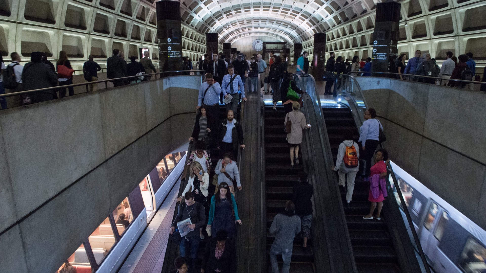 Metro riders moving through a station.