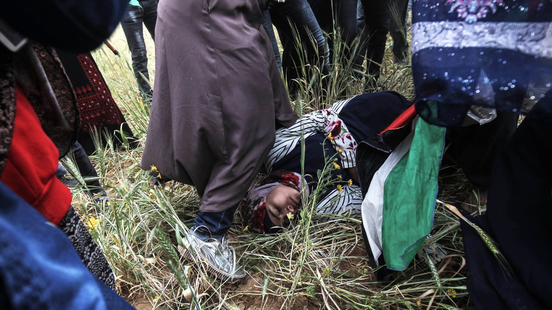 Injured Palestinian woman laying on the ground