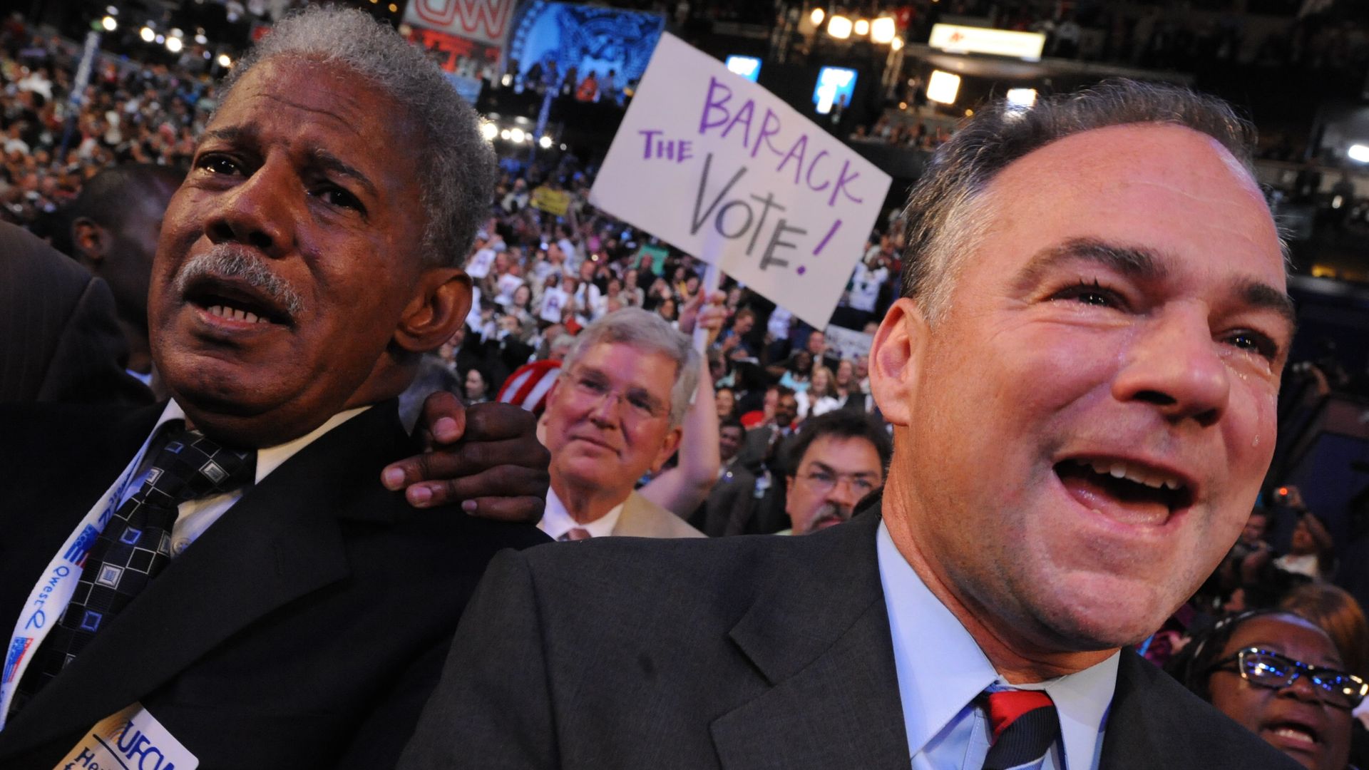 a pic of henry marsh with tim kaine in front of a crowd. Someone in the back has a sign that says "barack the vote"