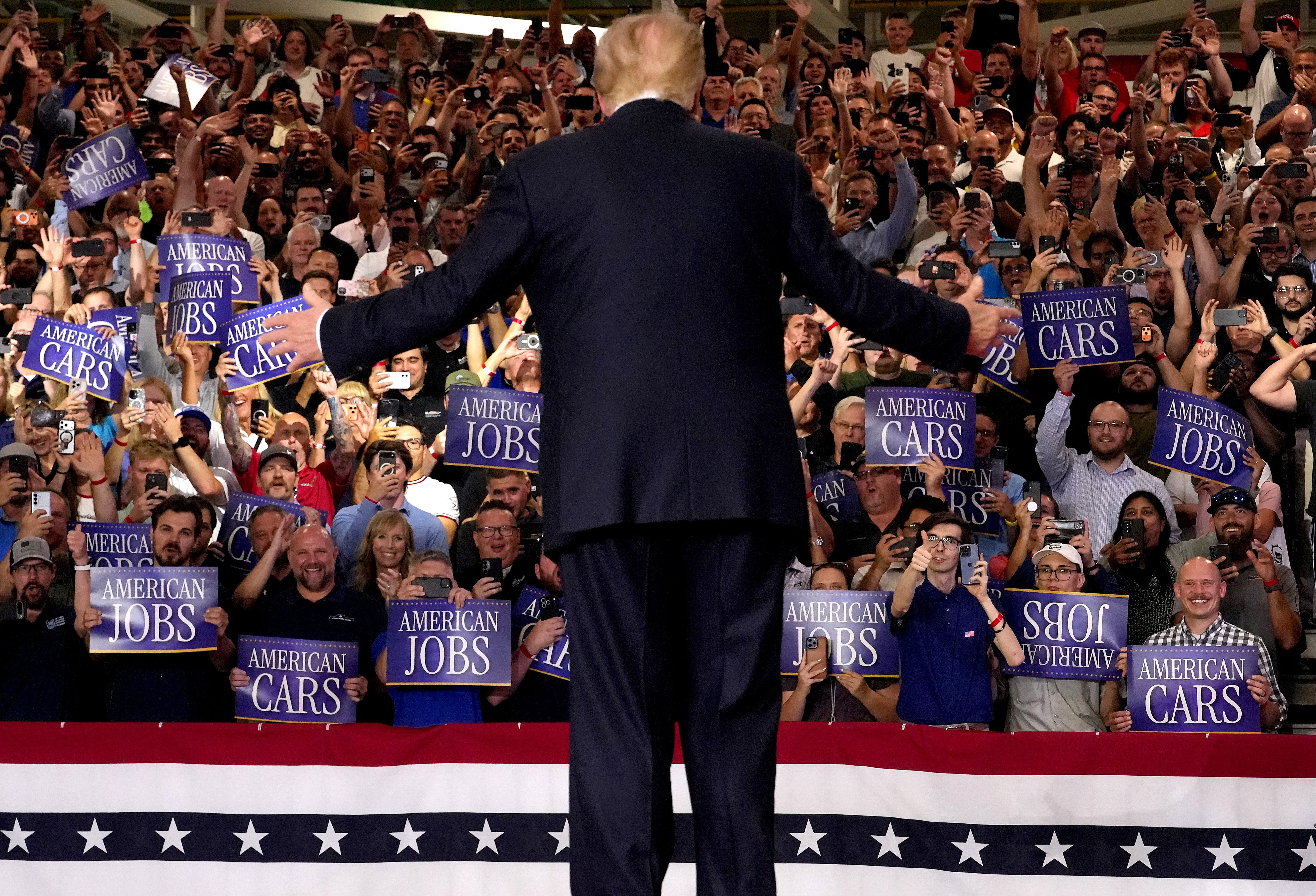 President Trump arrives for a speech at GM's Milford Proving Ground in Michigan yesterday. 