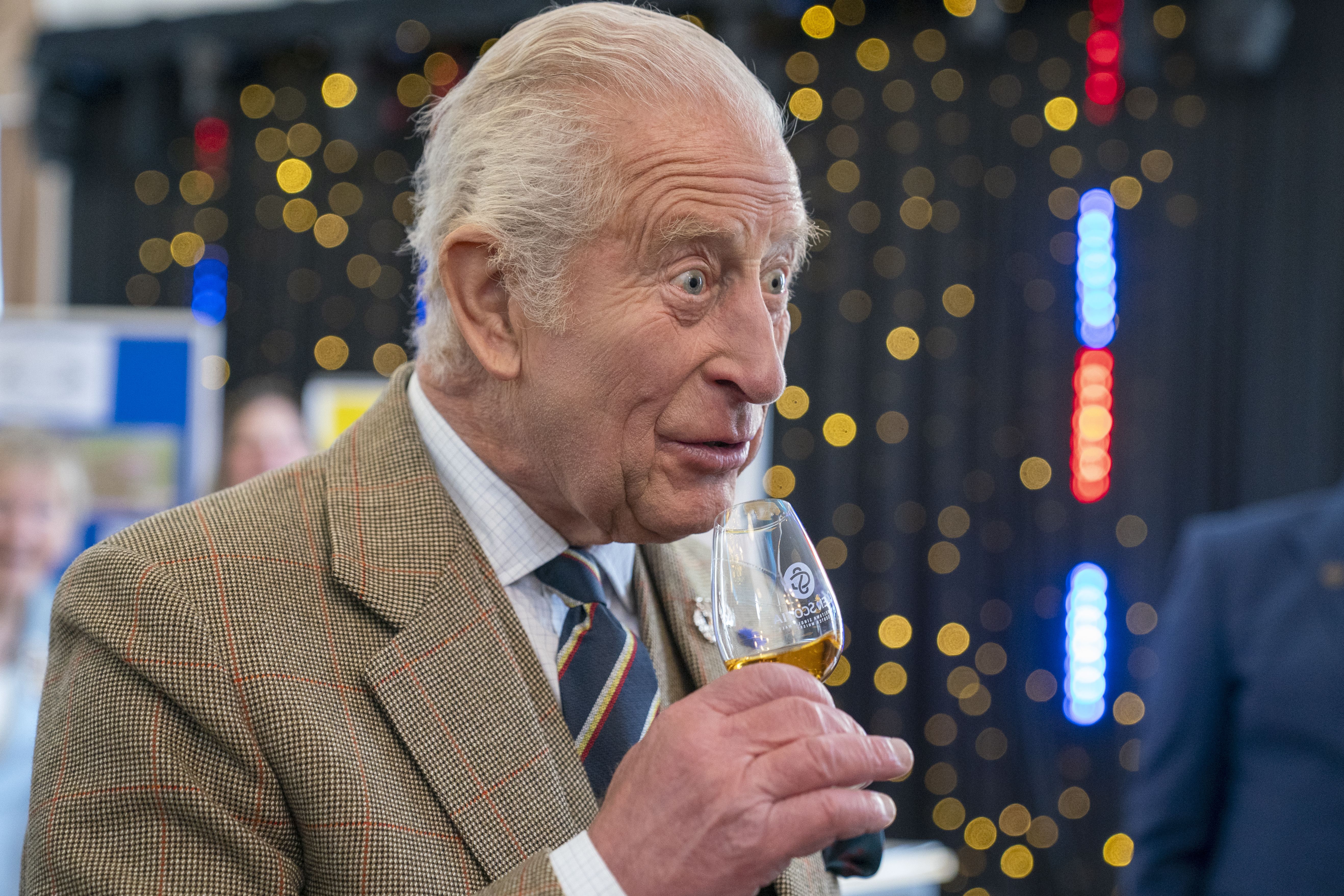 King Charles III drinks whisky