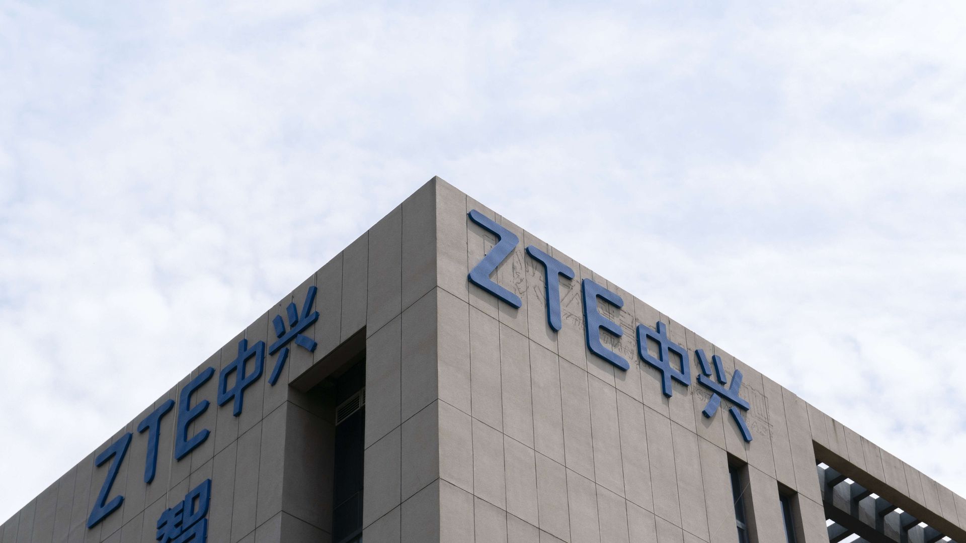 Corner of a building with ZTE logo against blue sky
