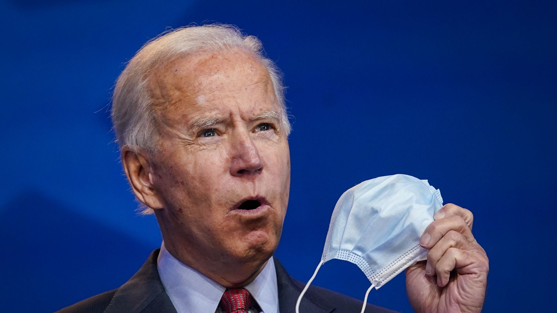 Biden holds a mask
