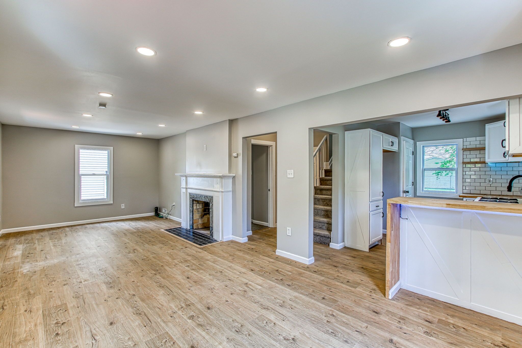 Interior view of 12786 Rosemary St. showing new floors and a fireplace.