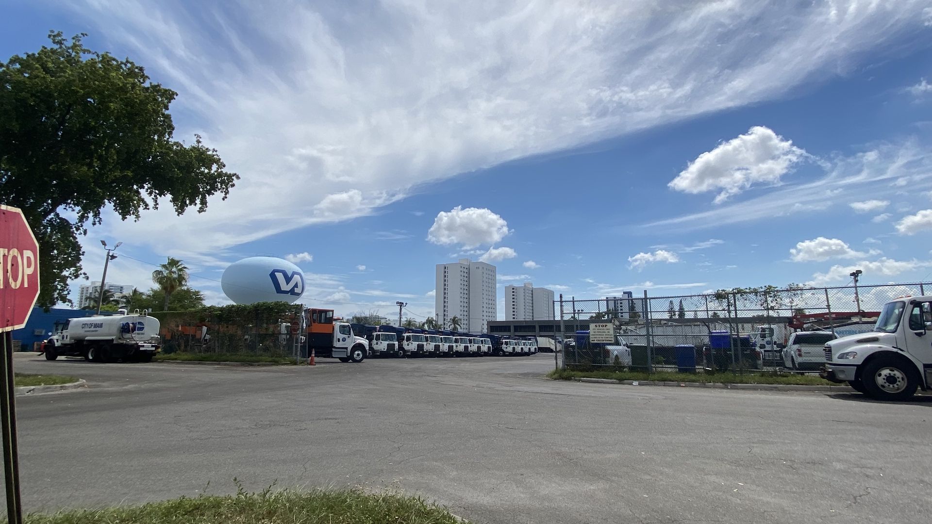A parking lot with a fleet of industrial trucks. 