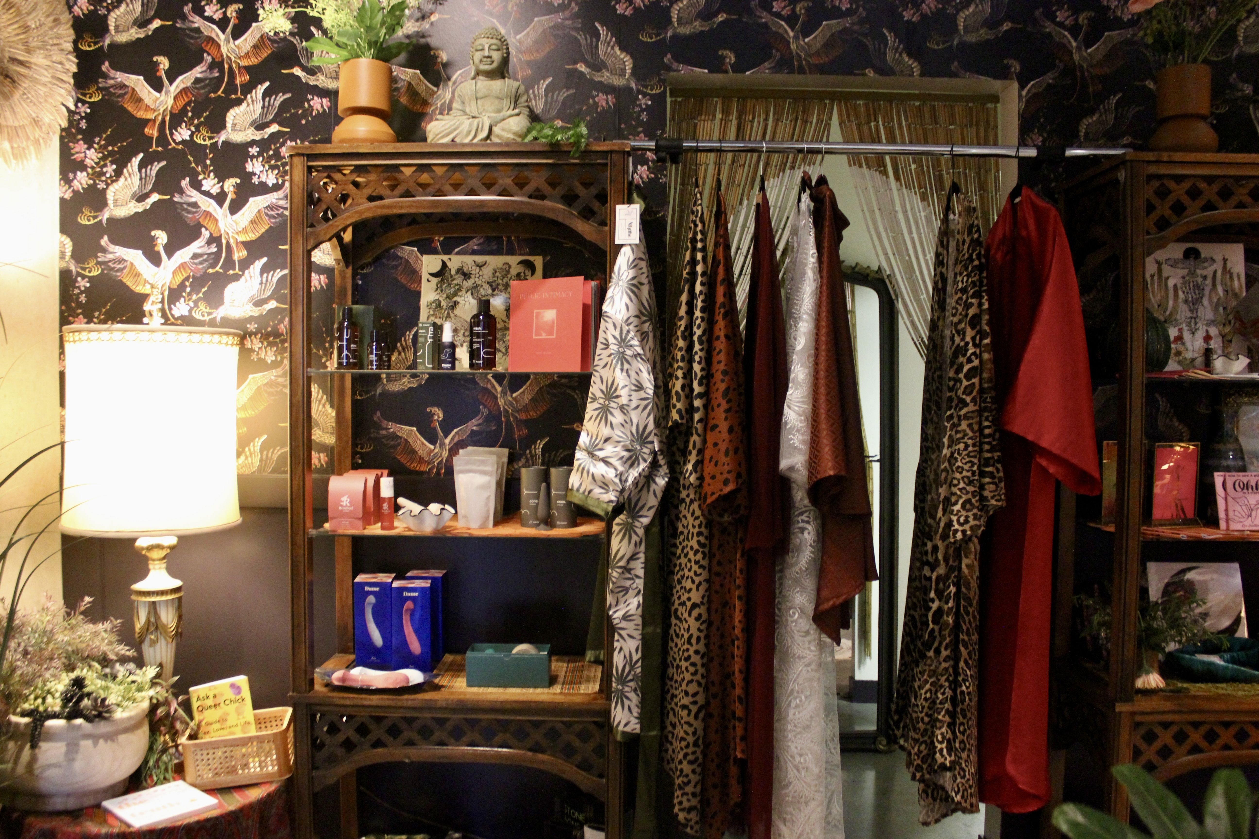 A photo of Zhoosh's backroom, with silk robes hanging on a closet rack.