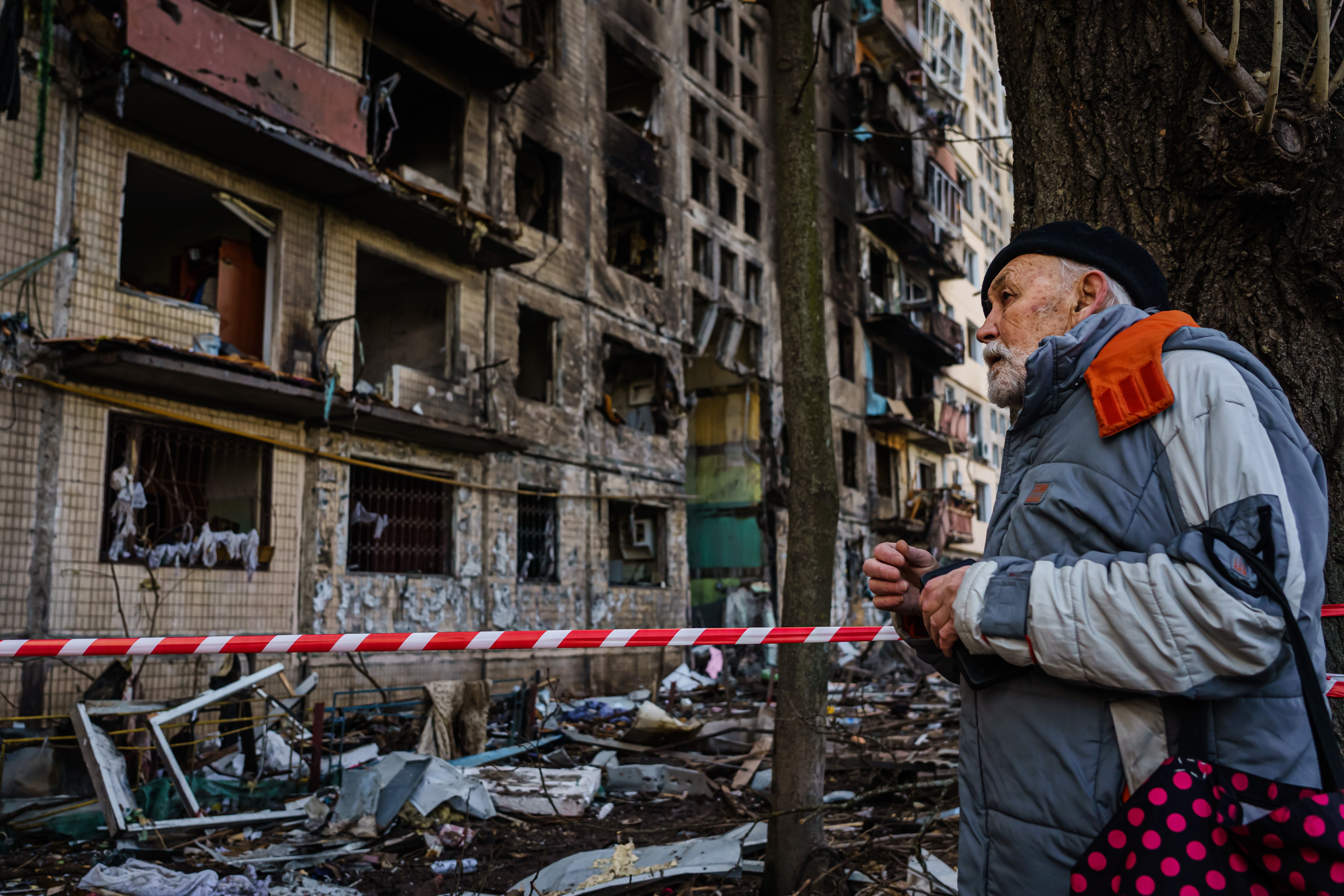 A man looks on at the damaged to apartment building, caused by what Kyiv officials call a Russian bombardment, in the Obolon neighborhood of Irpin, Ukraine, Monday, March 14.