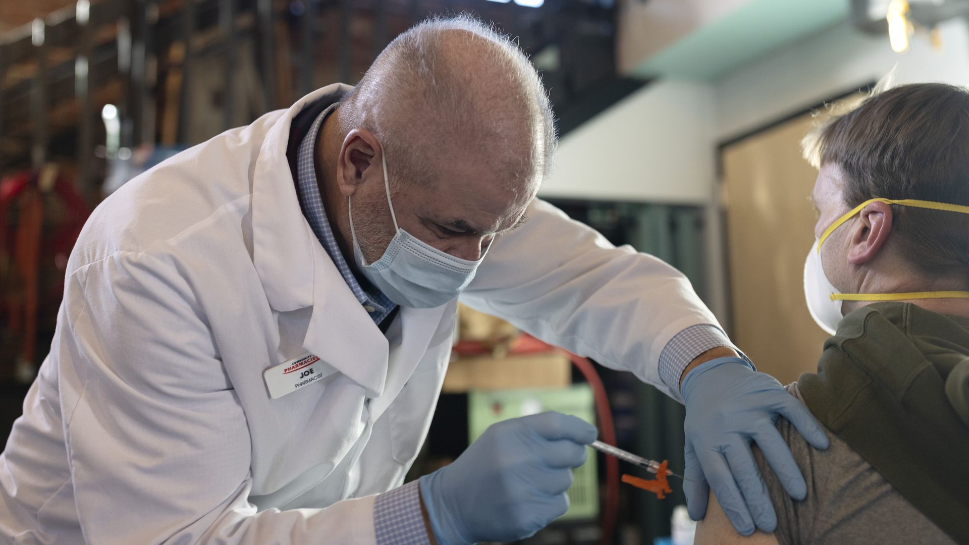 oe Bruno and Michael Coppi, from Community Pharmacy, give booster shots of COVID-19 vaccines at Goodfire Brewings Booze-ter Clinic, on Saturday, January 8, 2022.