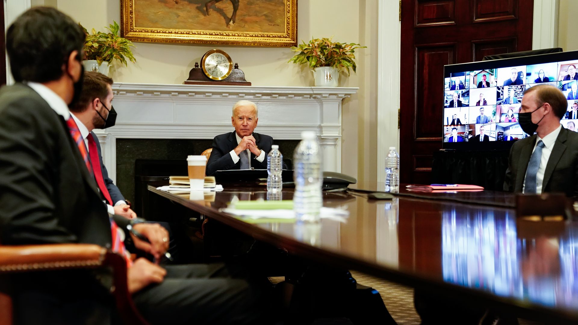 Biden sits at a table with Deese
