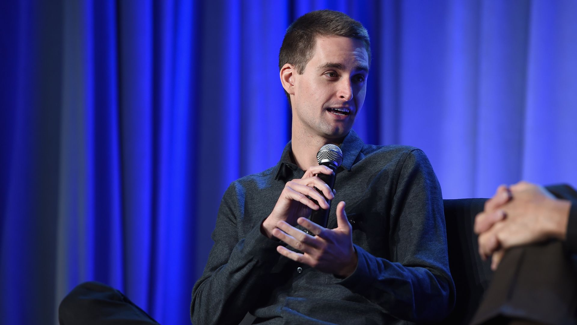 CEO and co-founder of Snapchat Evan Spiegel speaking onstage. 