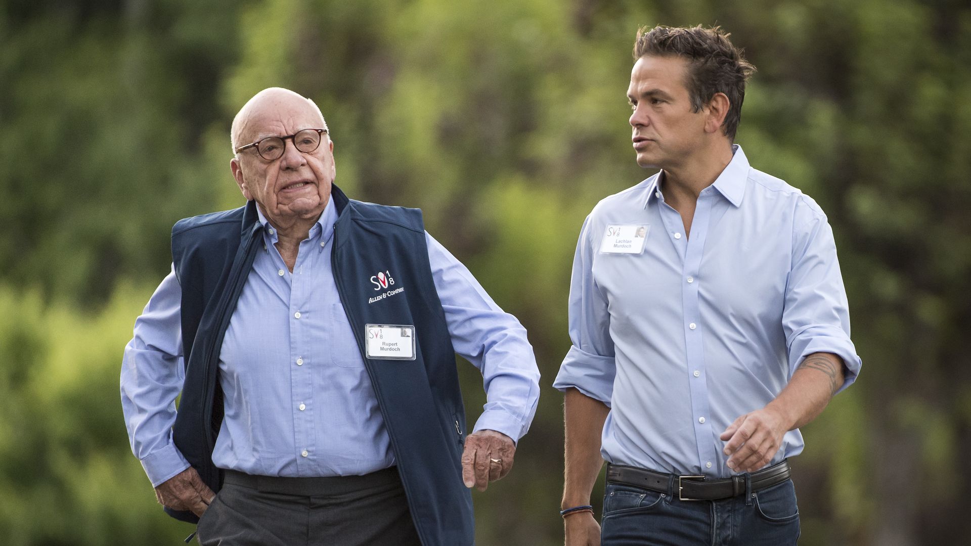 Rupert and Lachlan Murdoch talking to each other in casual clothing while walking.