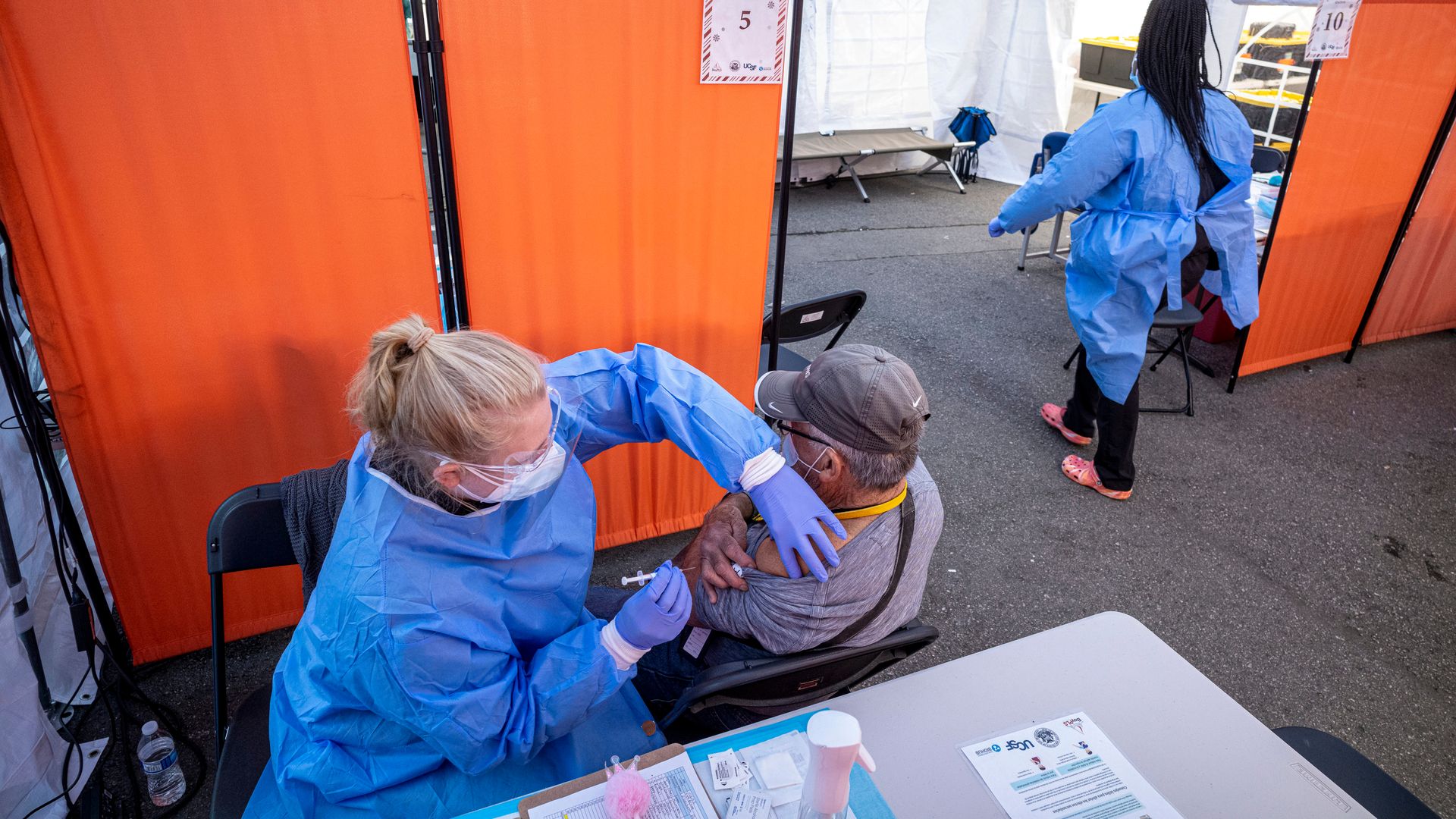 A healthcare worker administers a Pfizer-BioNTech Covid-19 vaccine at a vaccination site in San Francisco, California, U.S., on Monday, Jan. 10, 2022.