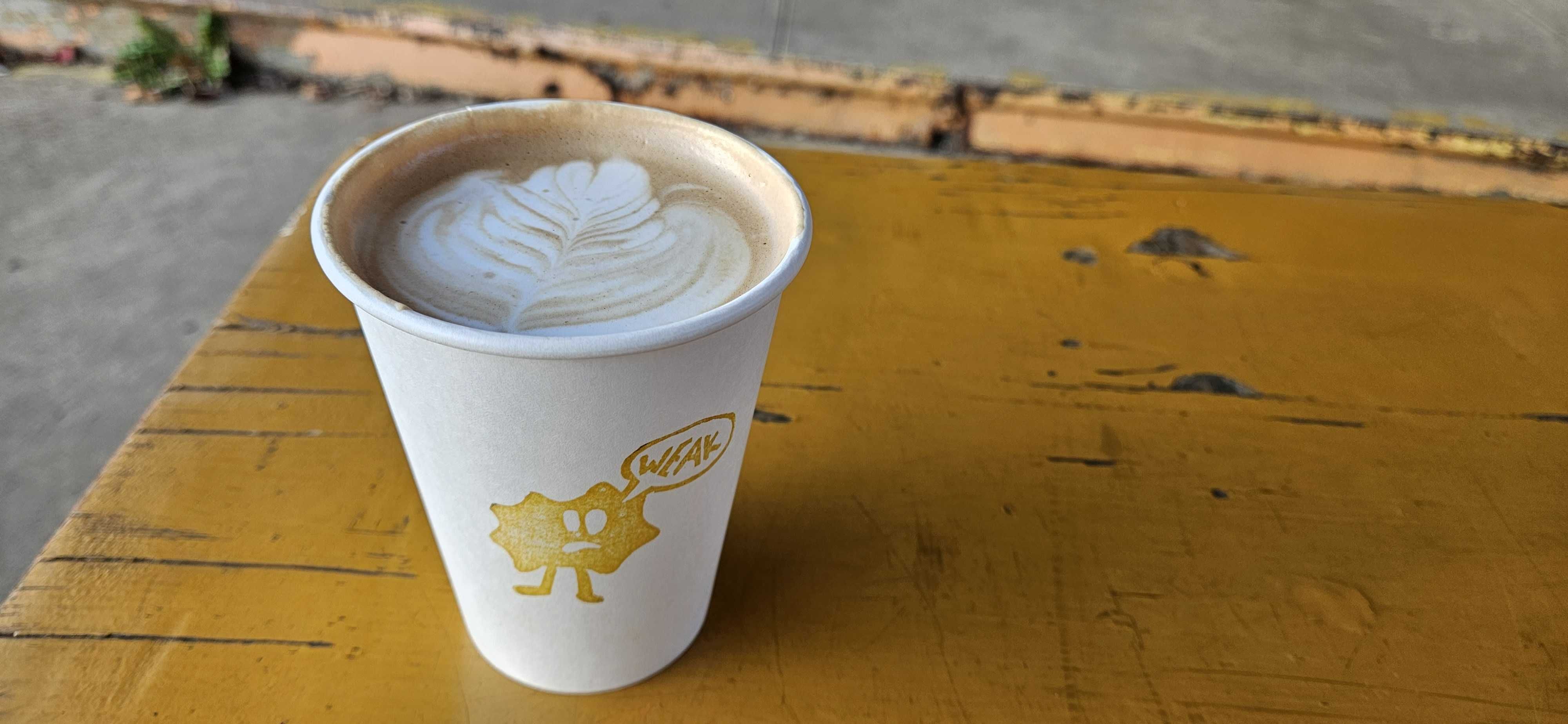 A mocha cup sitting on a picnic table.