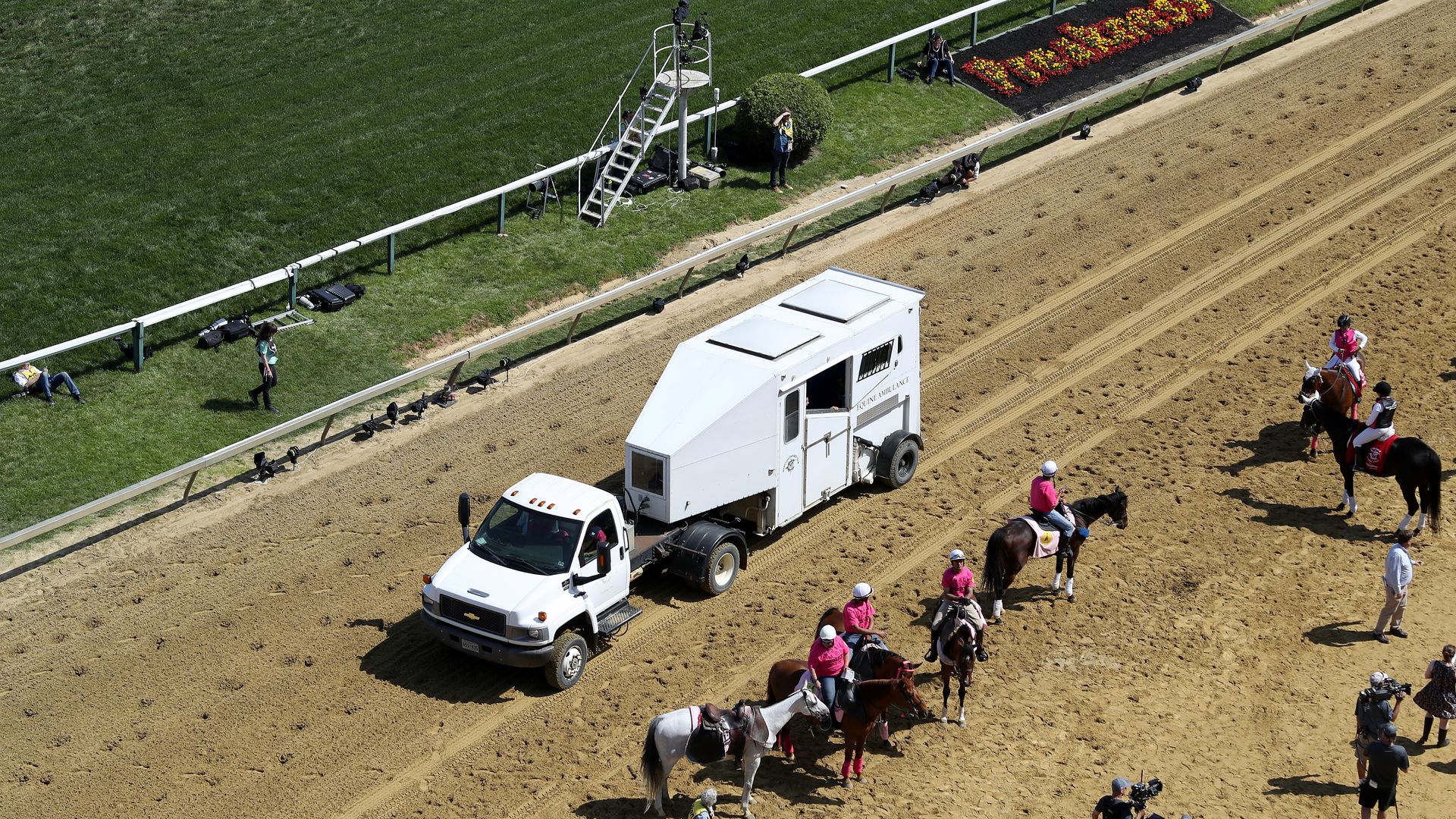A horse ambulance retrieves a horse body from the race course