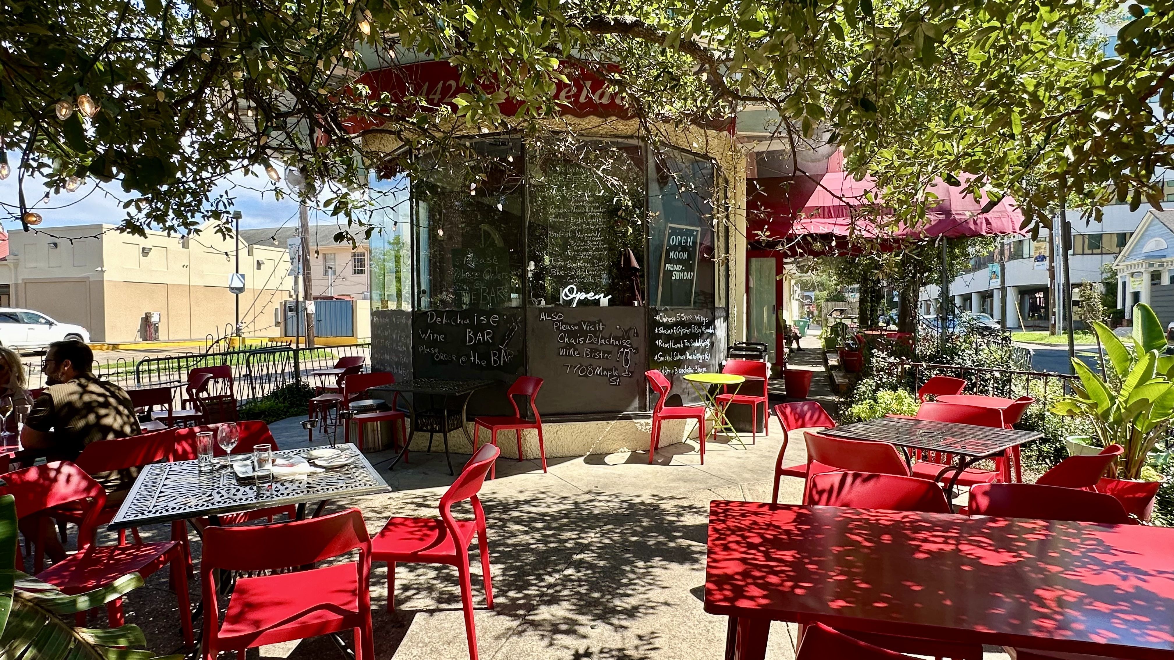 Photo shows red tables outside Delachaise Wine Bar.