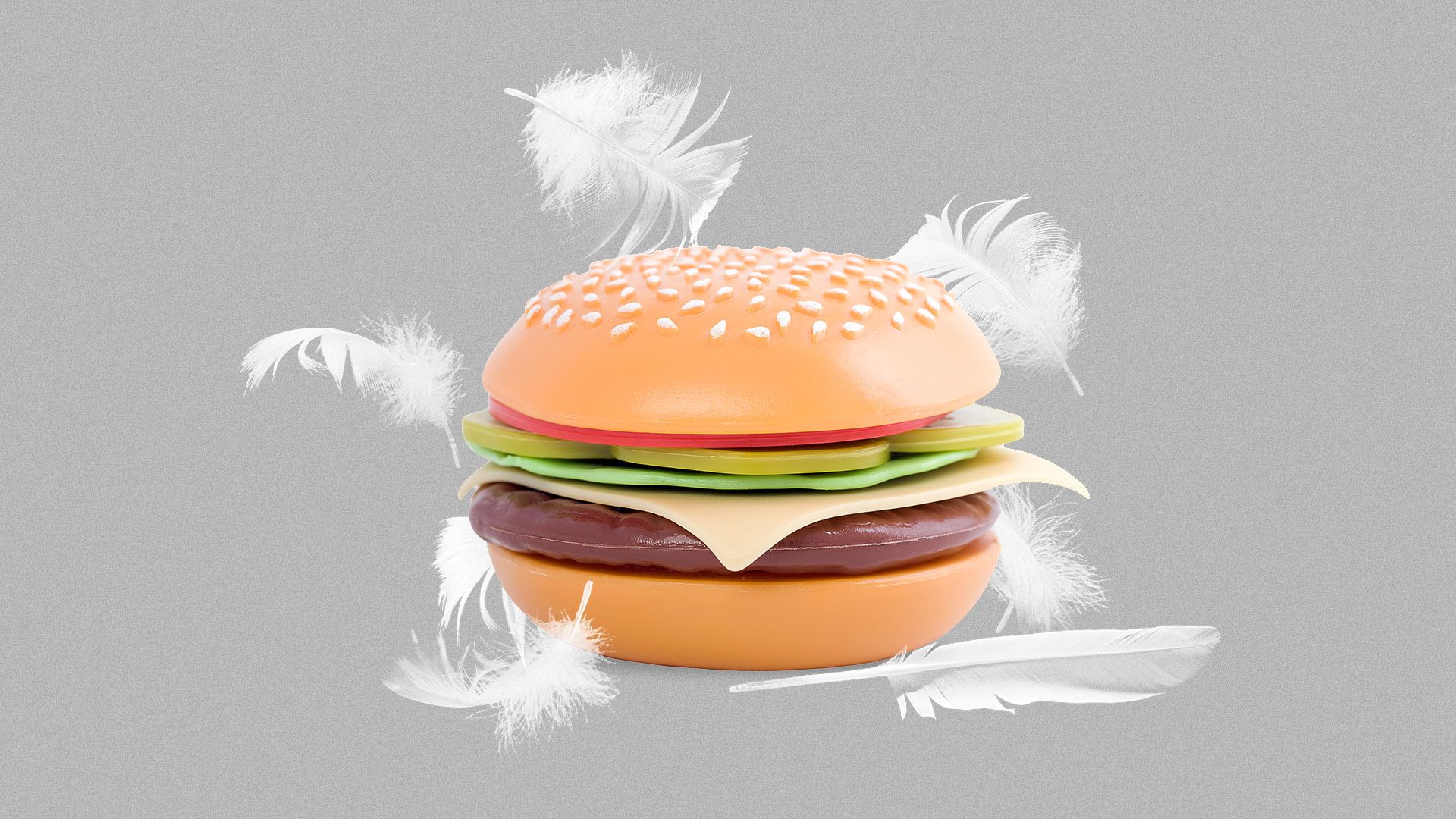 Illustration of a plastic hamburger surrounded by chicken feathers.
