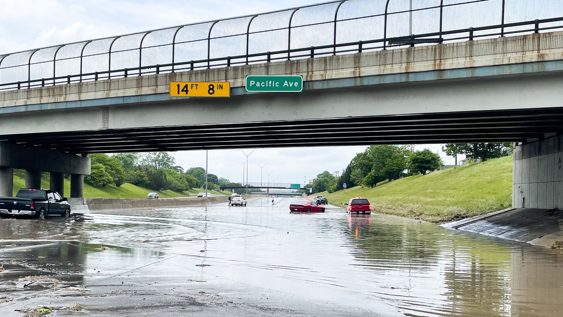 Cars abandoned at this I-96 overpass of Pacific Ave. causing the freeway to become impassible where the water was over 2 feet due to the rains in Northwest Detroit on Saturday June 26 in Detroit