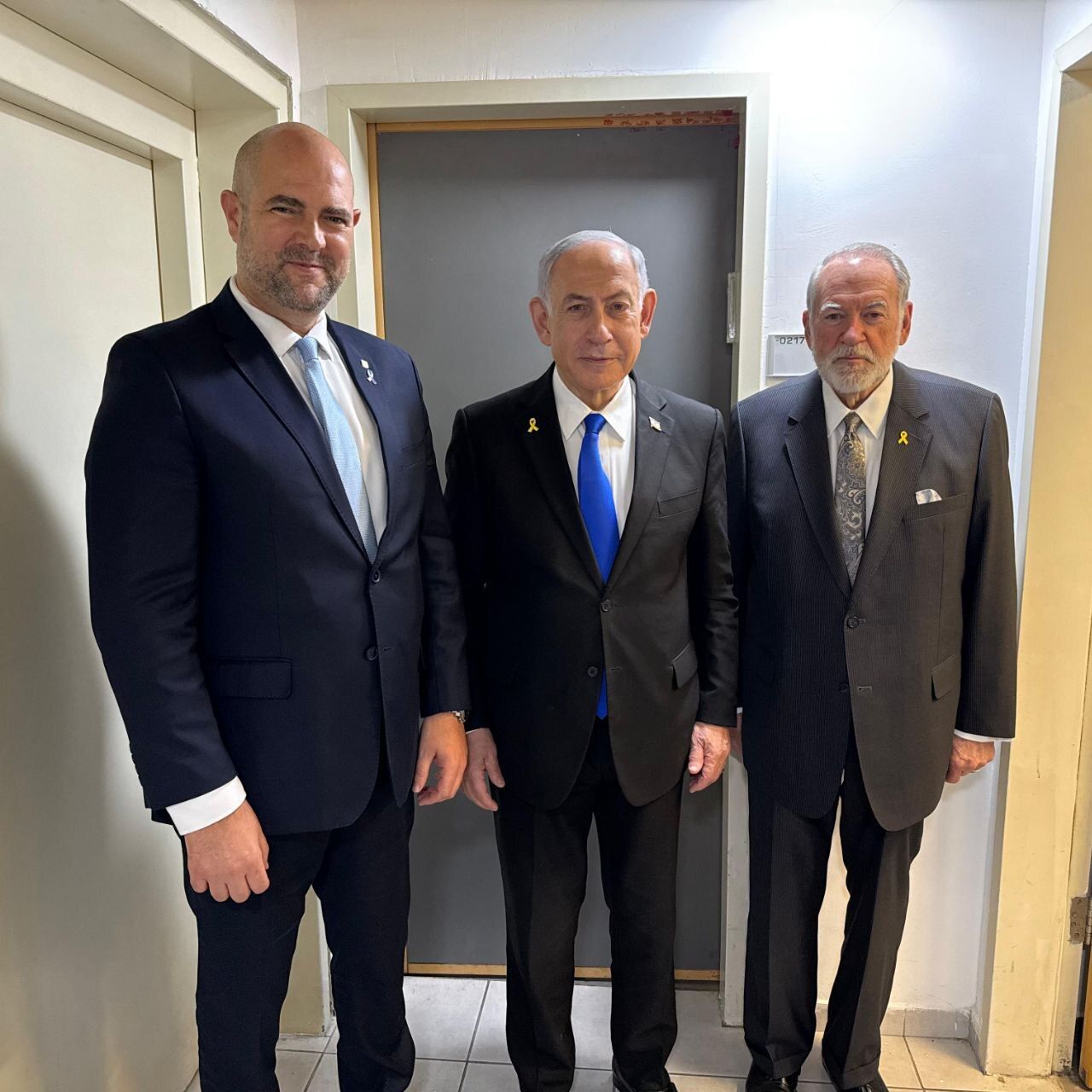 Mike Huckabee, the U.S. Ambassador to Israel (right), with Israeli Prime Minister Benjamin Netanyahu (center) and Israel Knesset Speaker Amir Ohana. The three met met in Tel Aviv at Netanyahu's corruption trial on Wednesday.