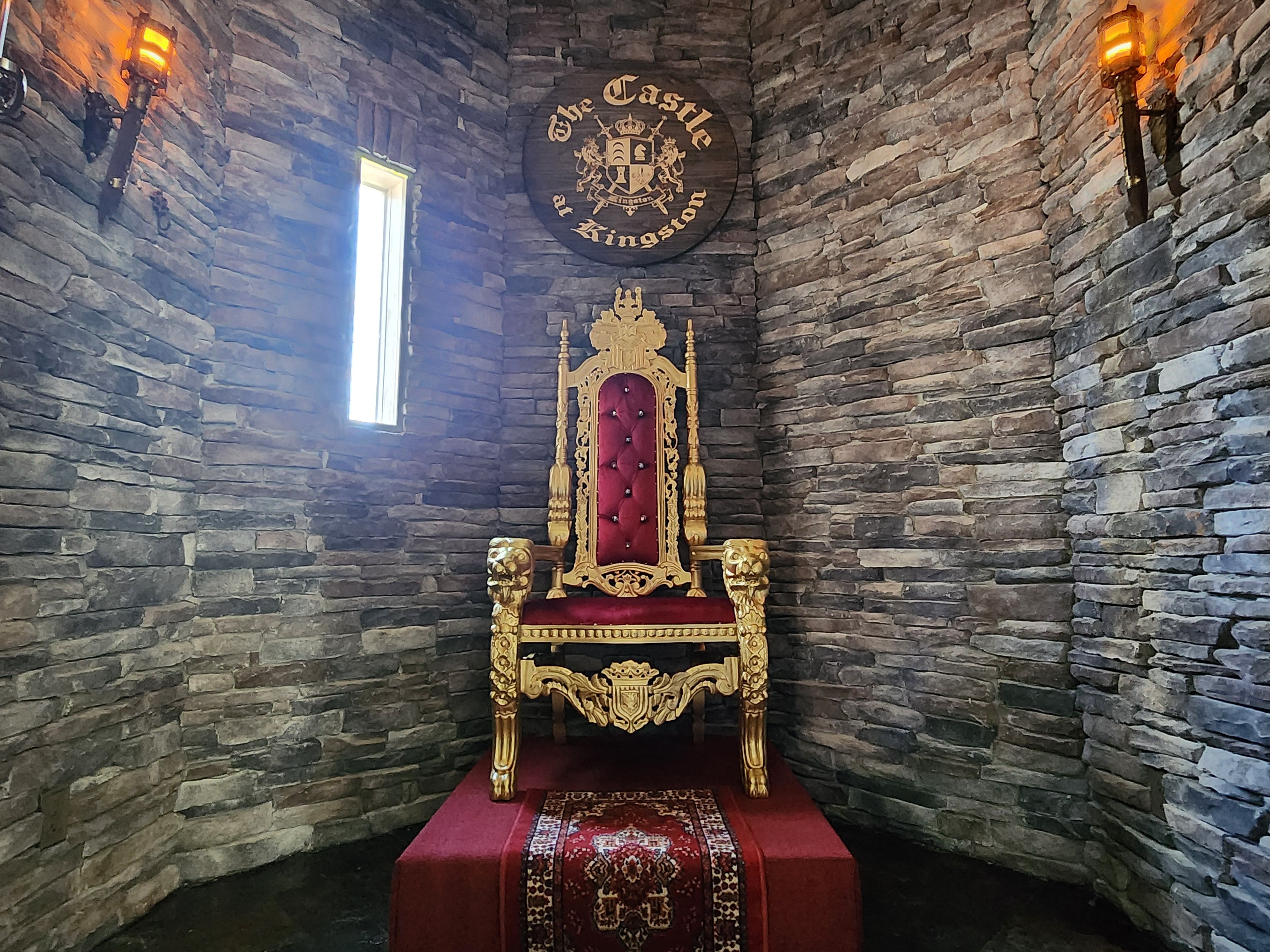 A chair that looks like a throne sits in a small room inside The Castle at Kingston