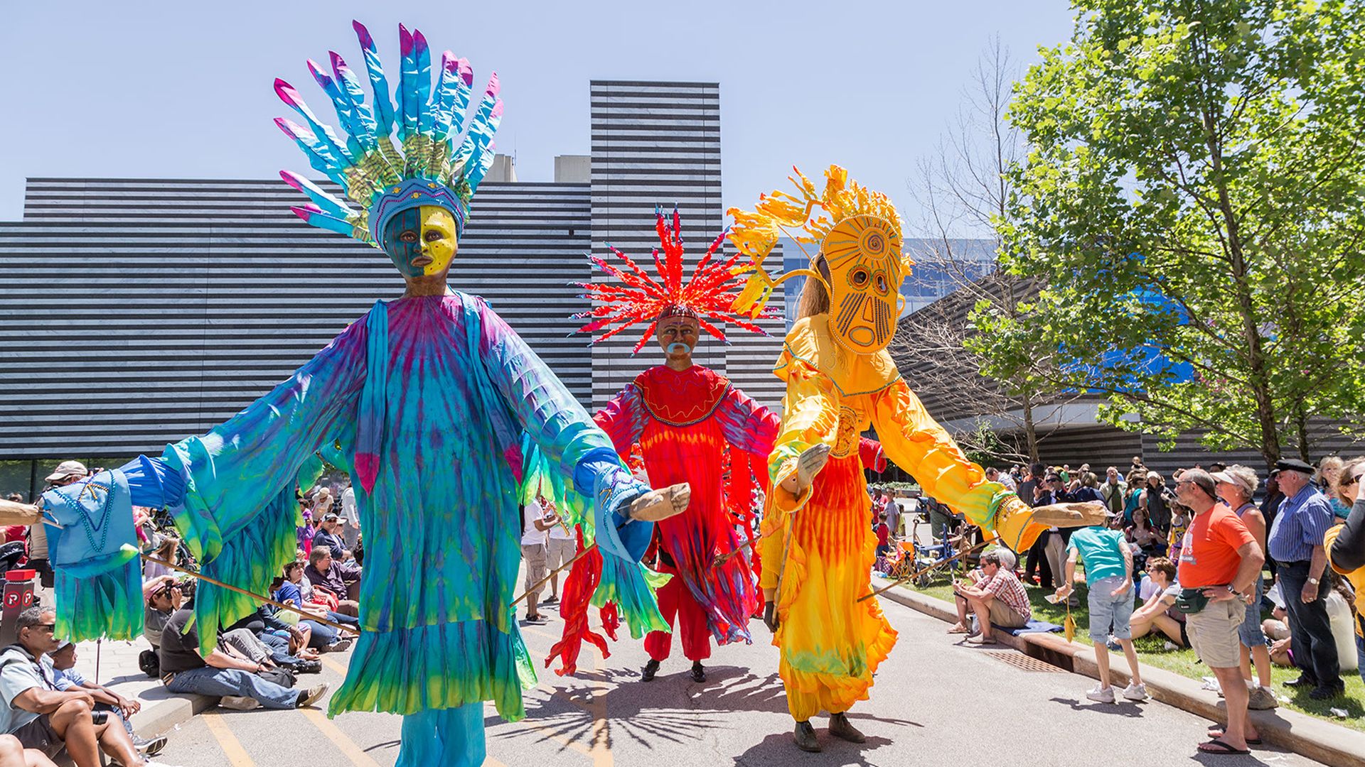 People in colorful costumes in a parade. 