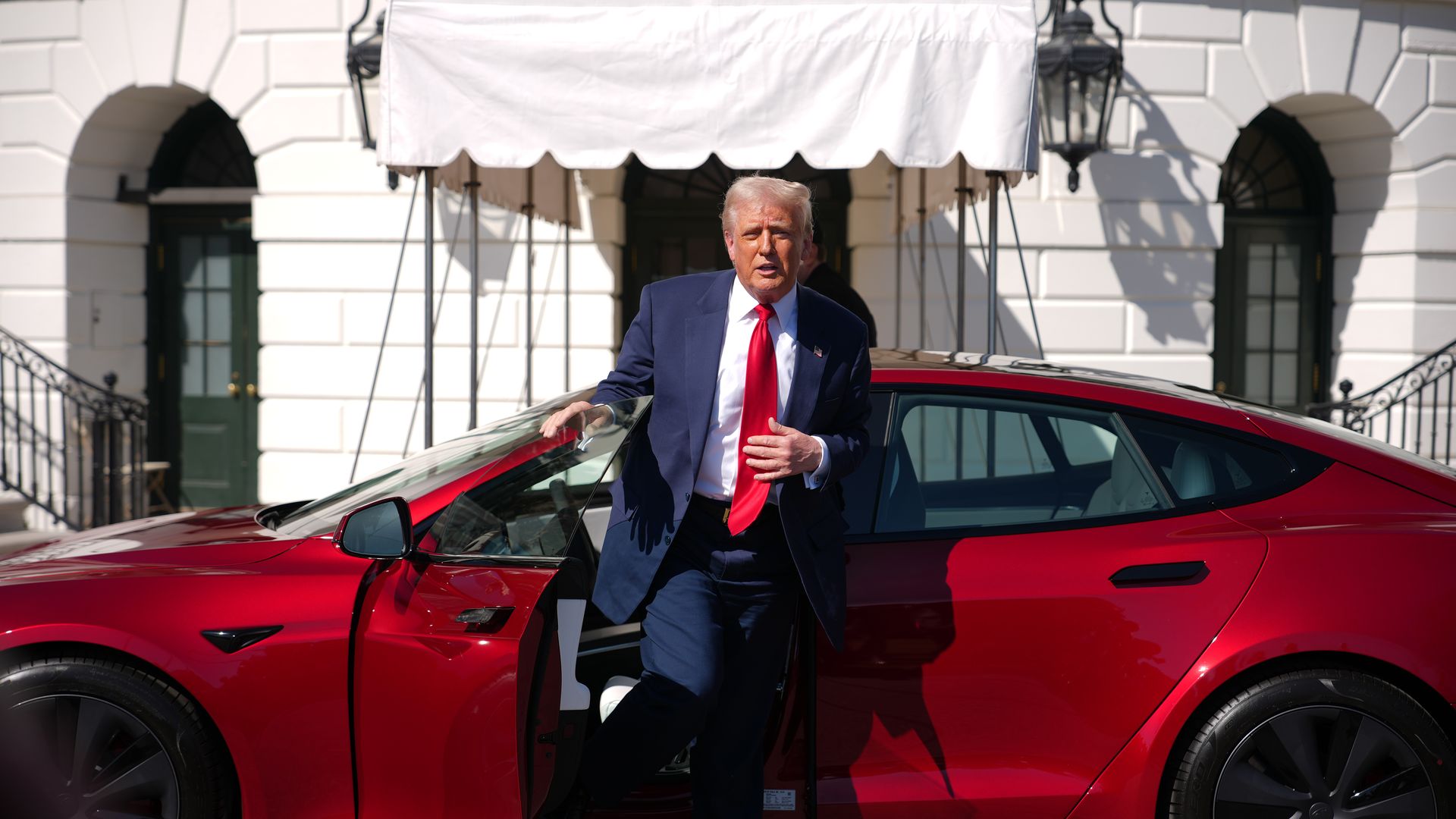 President Donald Trump gets out of a Tesla Model S on the South Lawn of the White House on March 11, 2025 in Washington, DC. Trump spoke out against calls for a boycott of Elon Musk's companies and said he would purchase a Tesla vehicle in what he calls a 'show of confidence and support' for Elon Mu