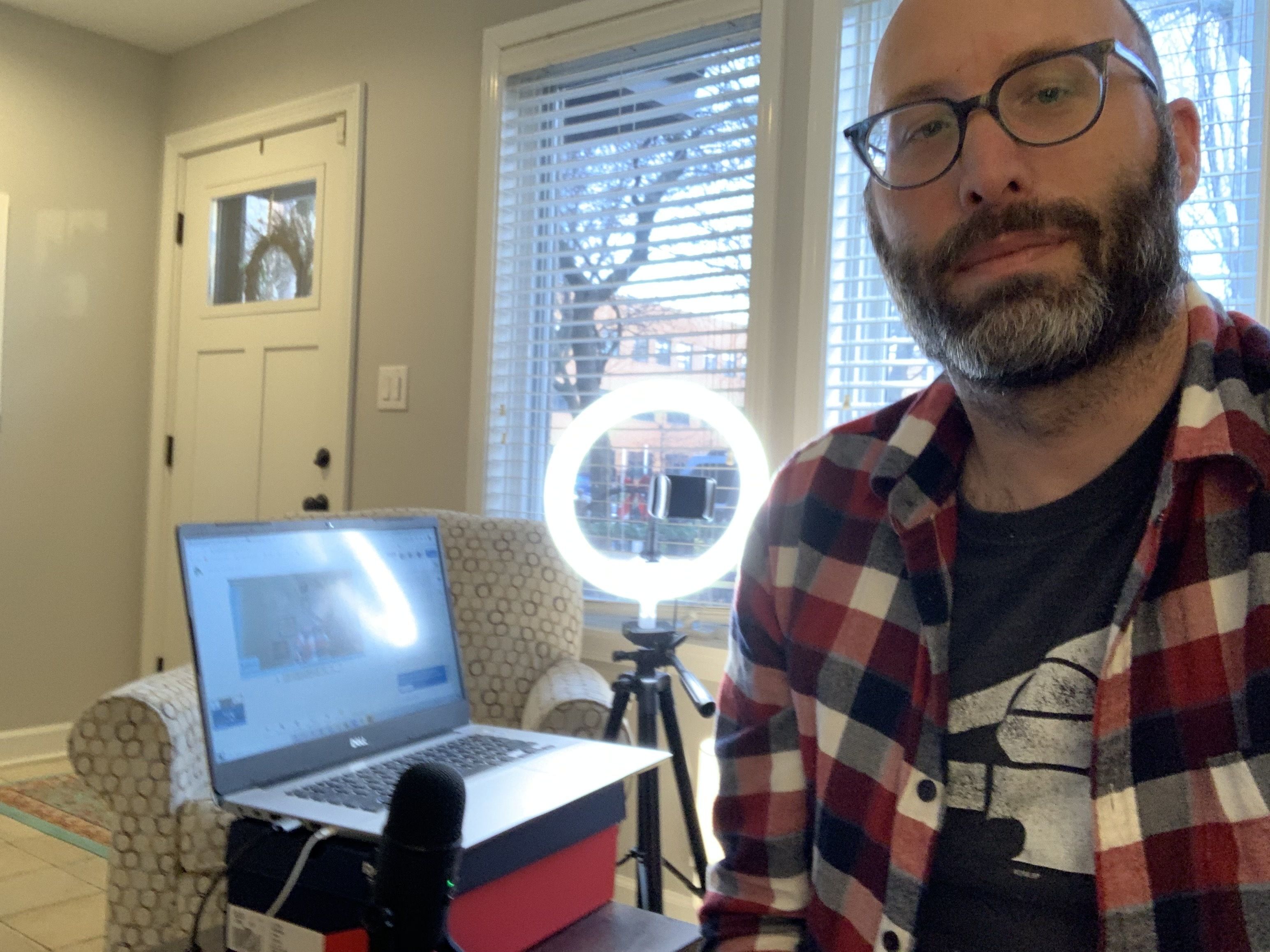 guy in front of a ring light 