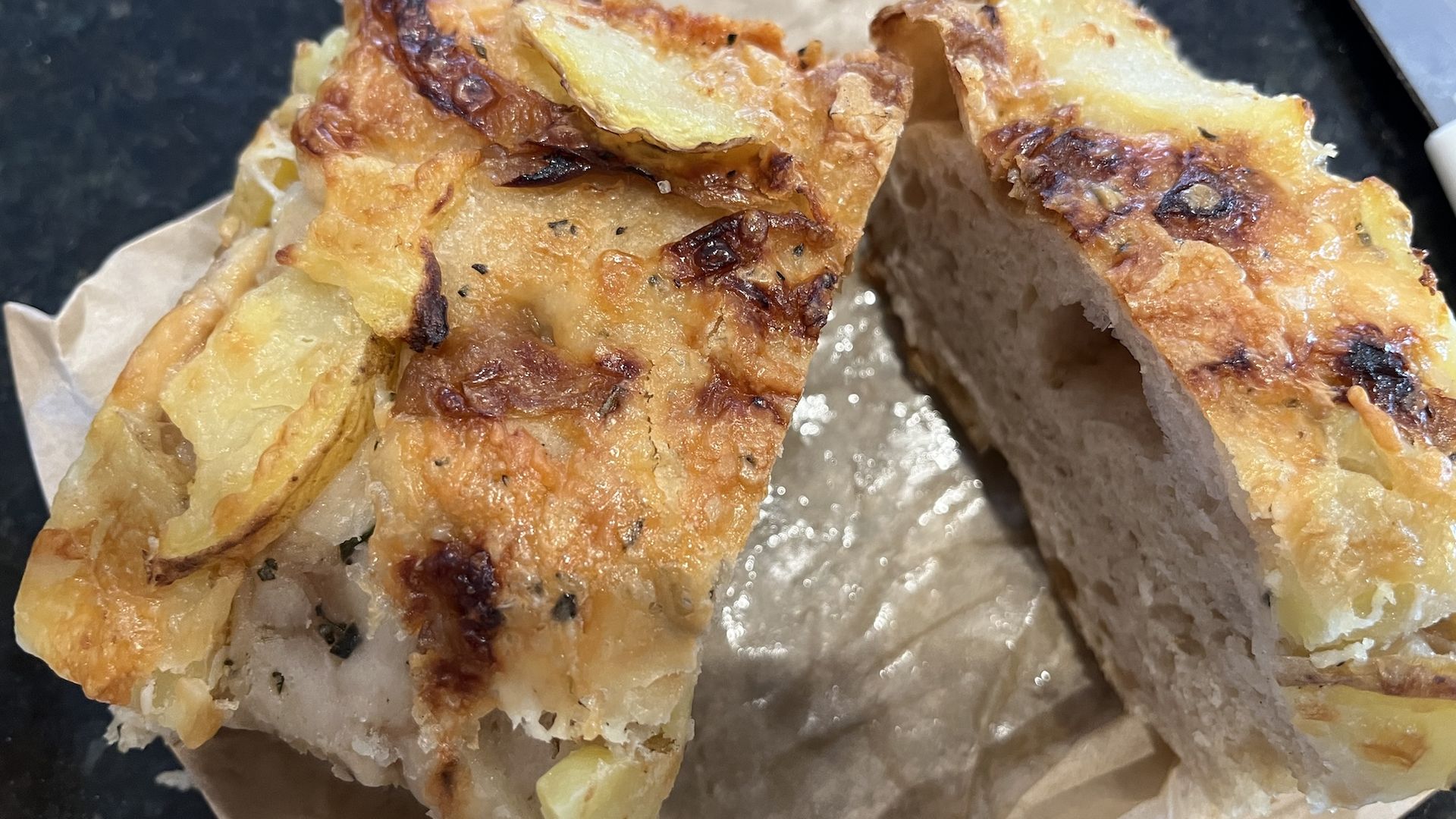 Potato and cheese focaccia cut in half.