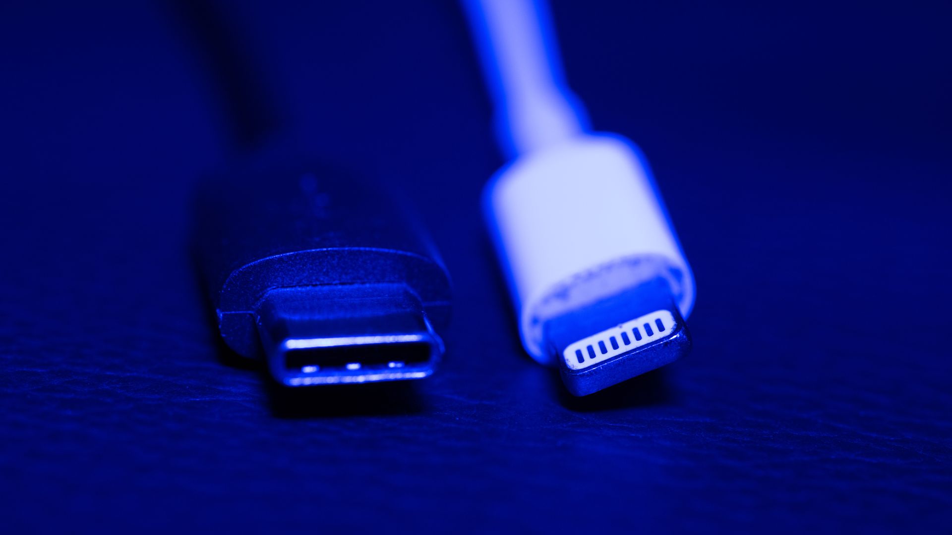 A USB-C charging plug next to Apple's Lightning charging plug 