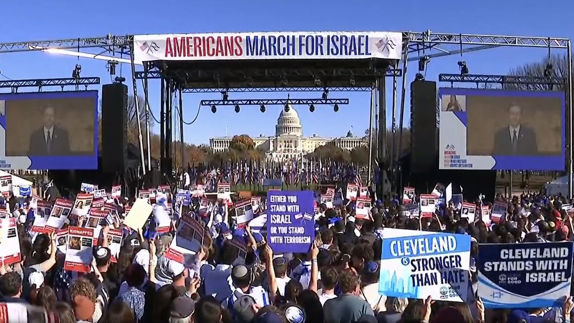 A crowd holding signs at the March for Israel