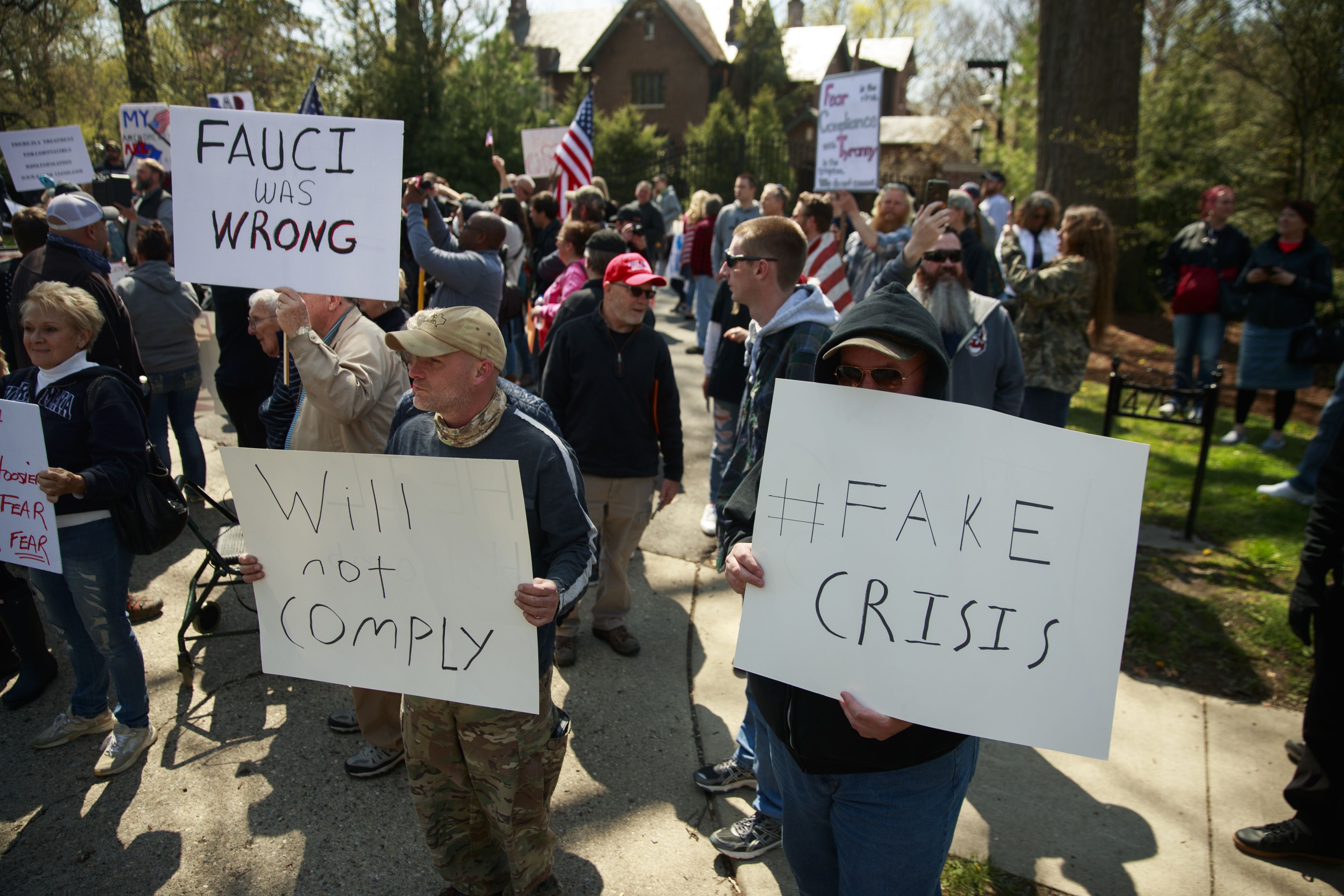Protesters gather outside Indiana Governor Eric Holcomb's mansion