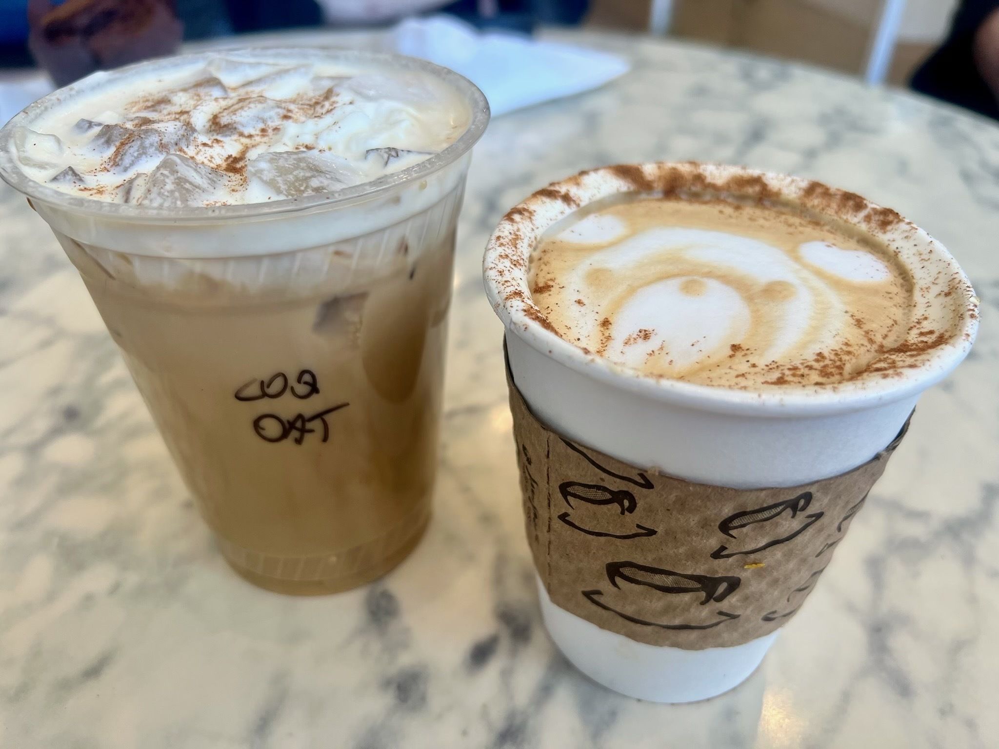Photo of two cup of coffee on a table. 