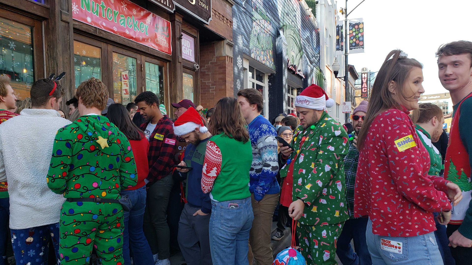 People waiting to get into a bar. 