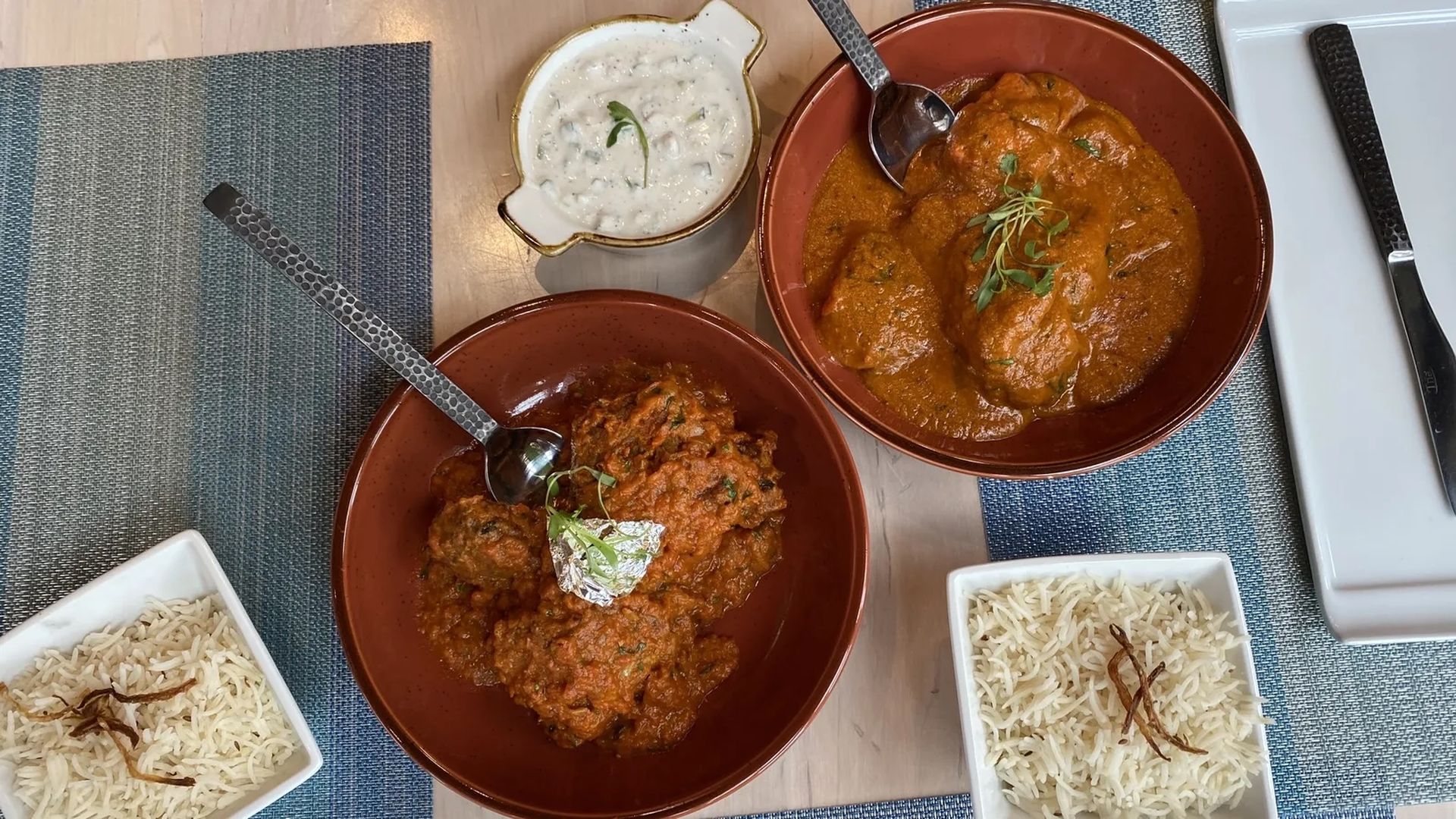 The zucchini kofta (left) and butter chicken at Kismet Modern Indian. Both are $22 at dinner. Photo: Karri Peifer/Axios