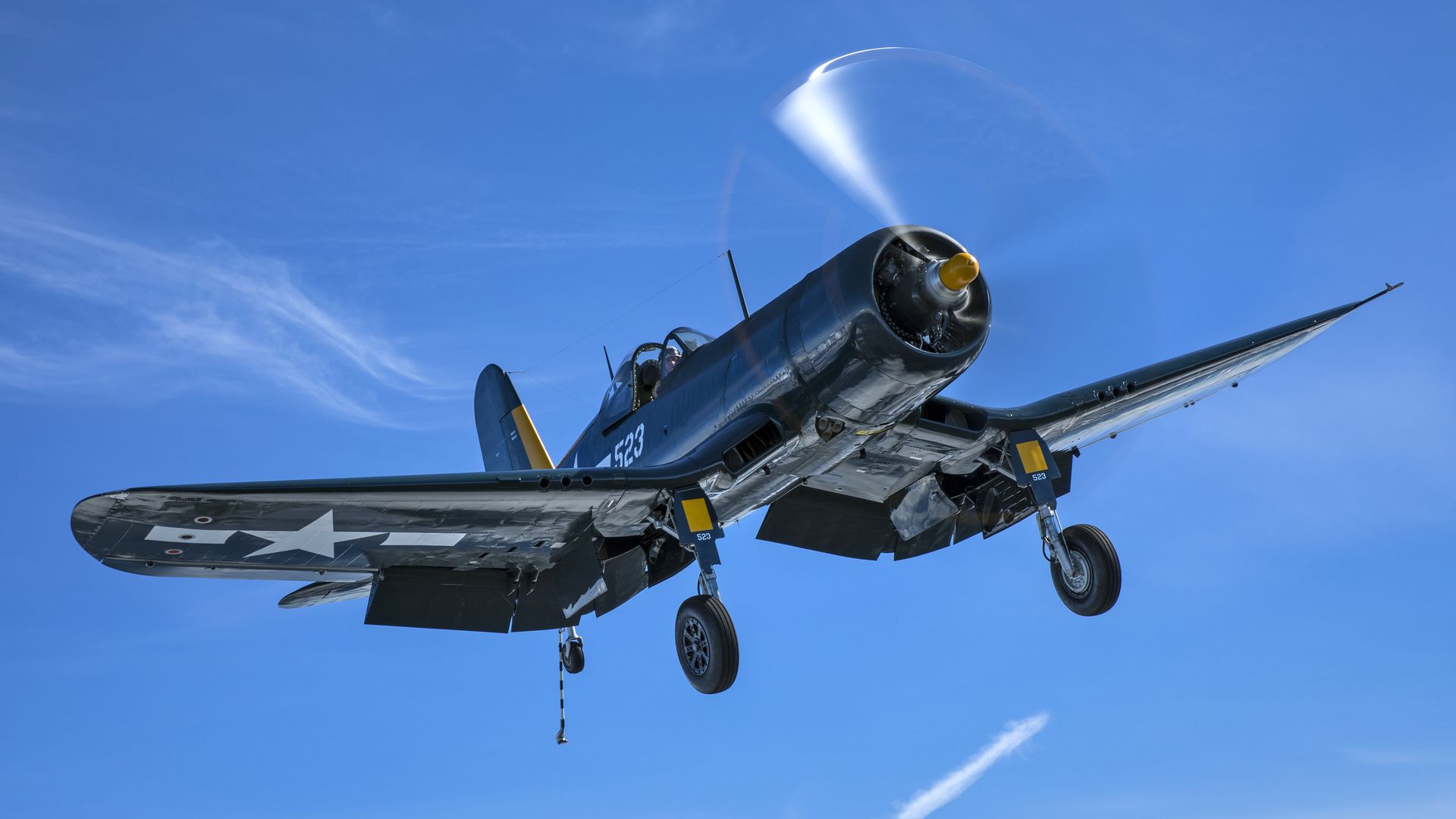 A photo of a U.S. FG-1D Corsair propeller airplane in the air.