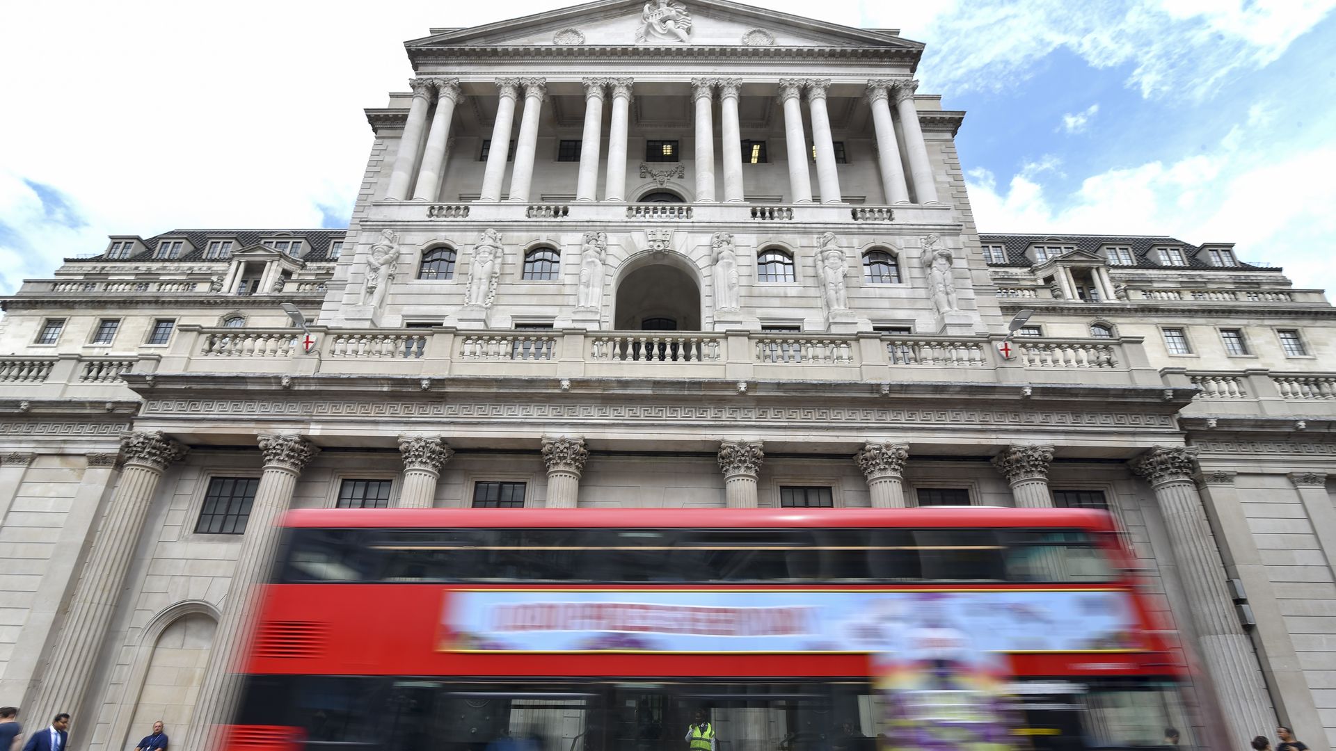 Bank of England with a double-decker zooming by