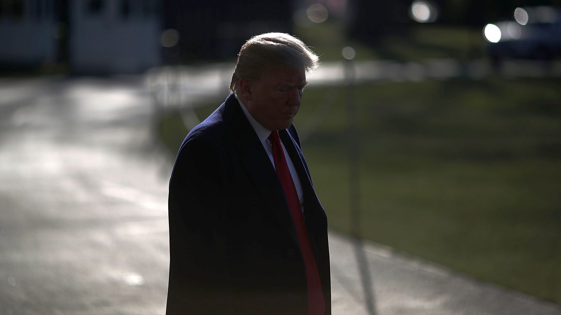 donald trump walking outside with his head down