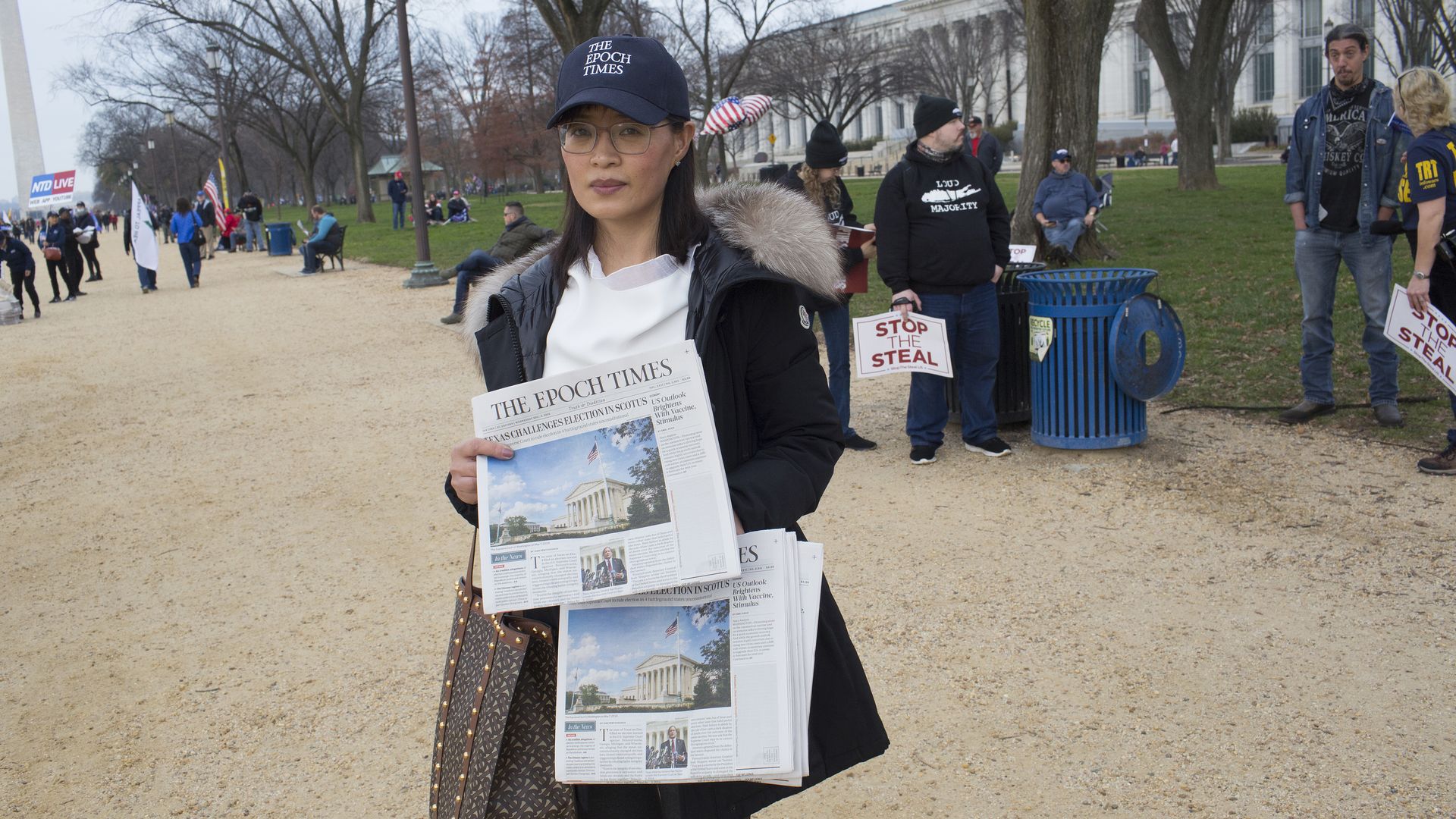 A vendor is seen distributing copies of the Epoch Times newspaper on the National Mall in Washington, D.C.