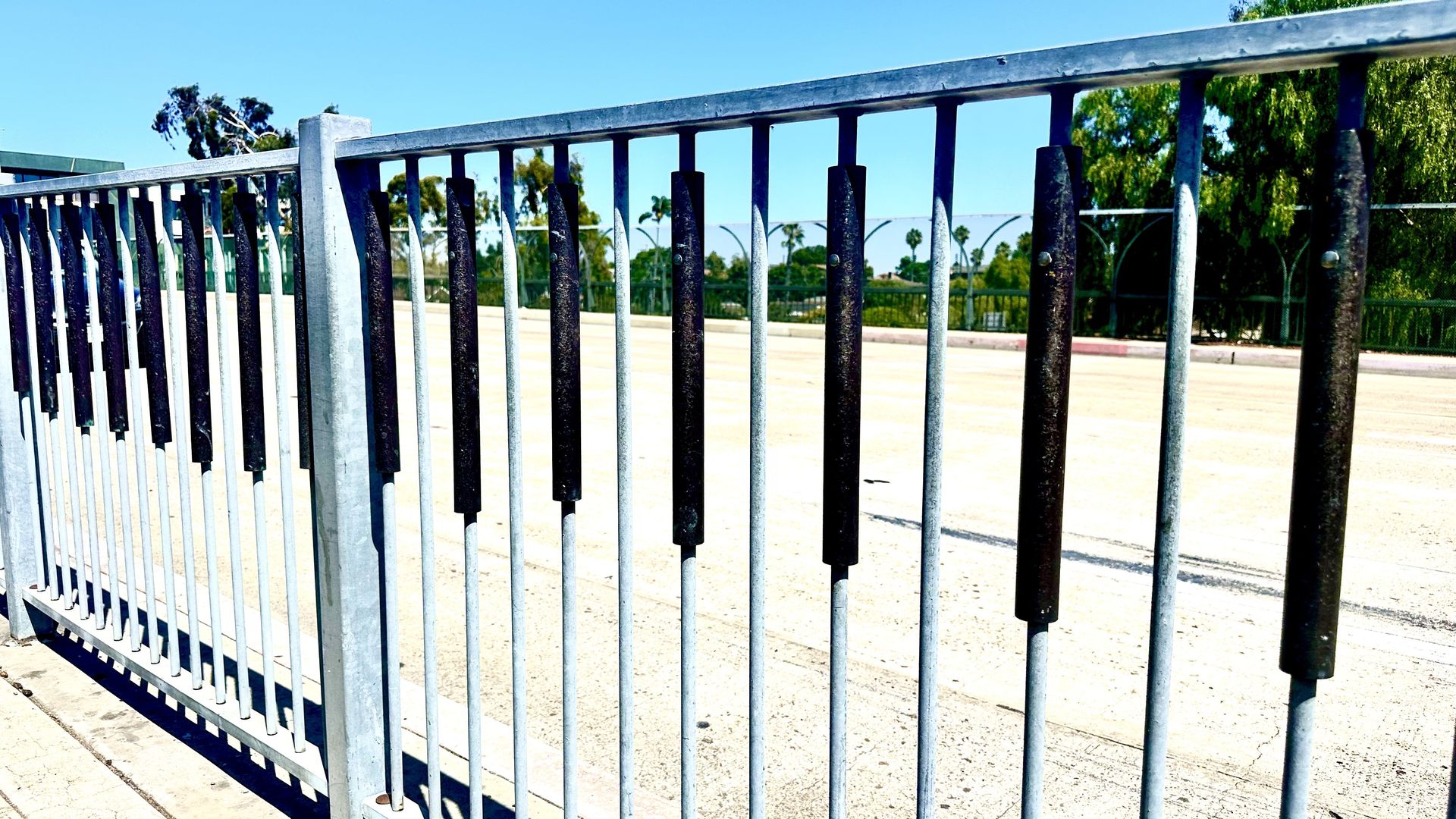 The railing of a sidewalk on a freeway overpass 