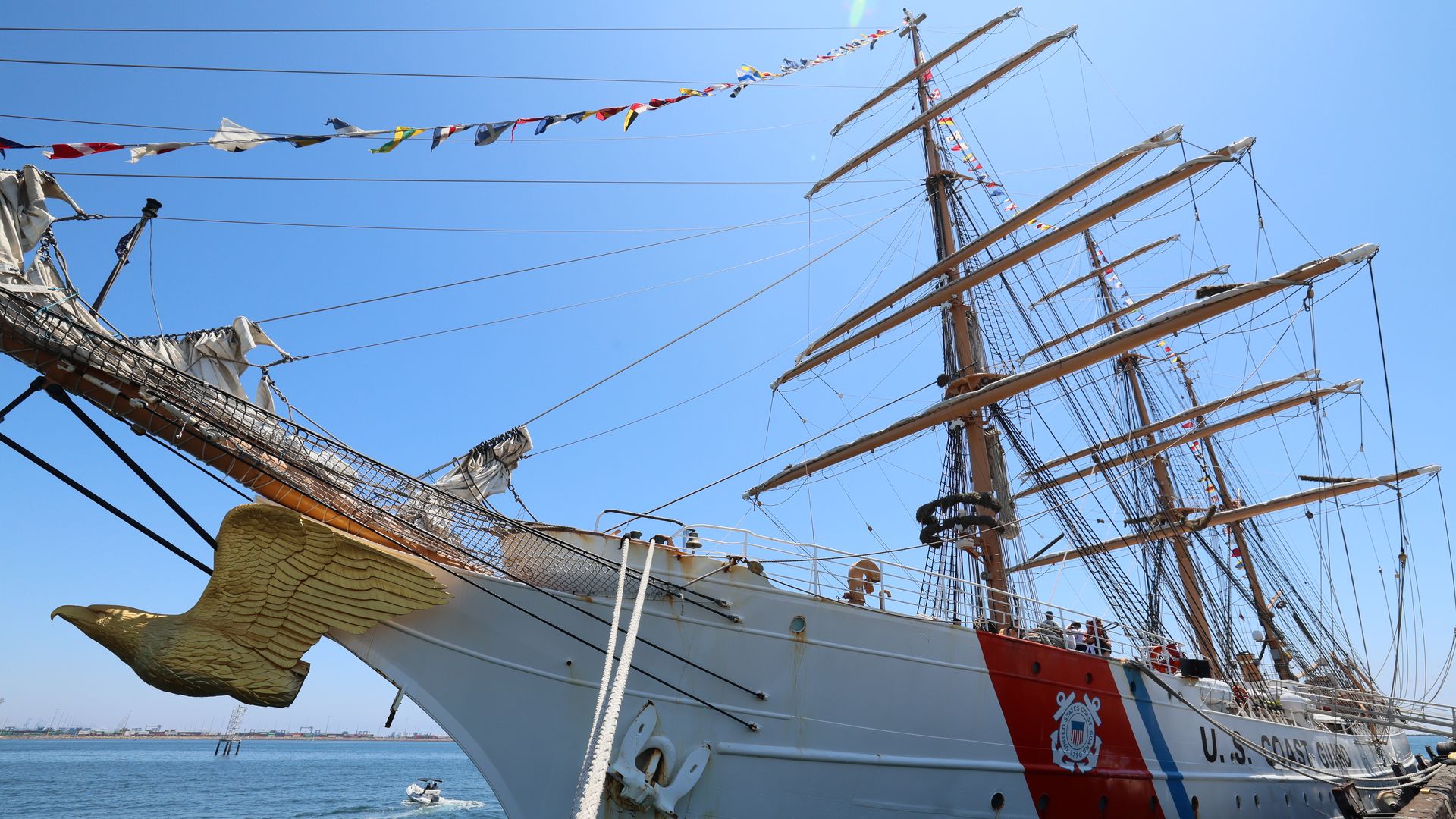 Image shows a golden eagle on the front of a Coast Guard tall ship.