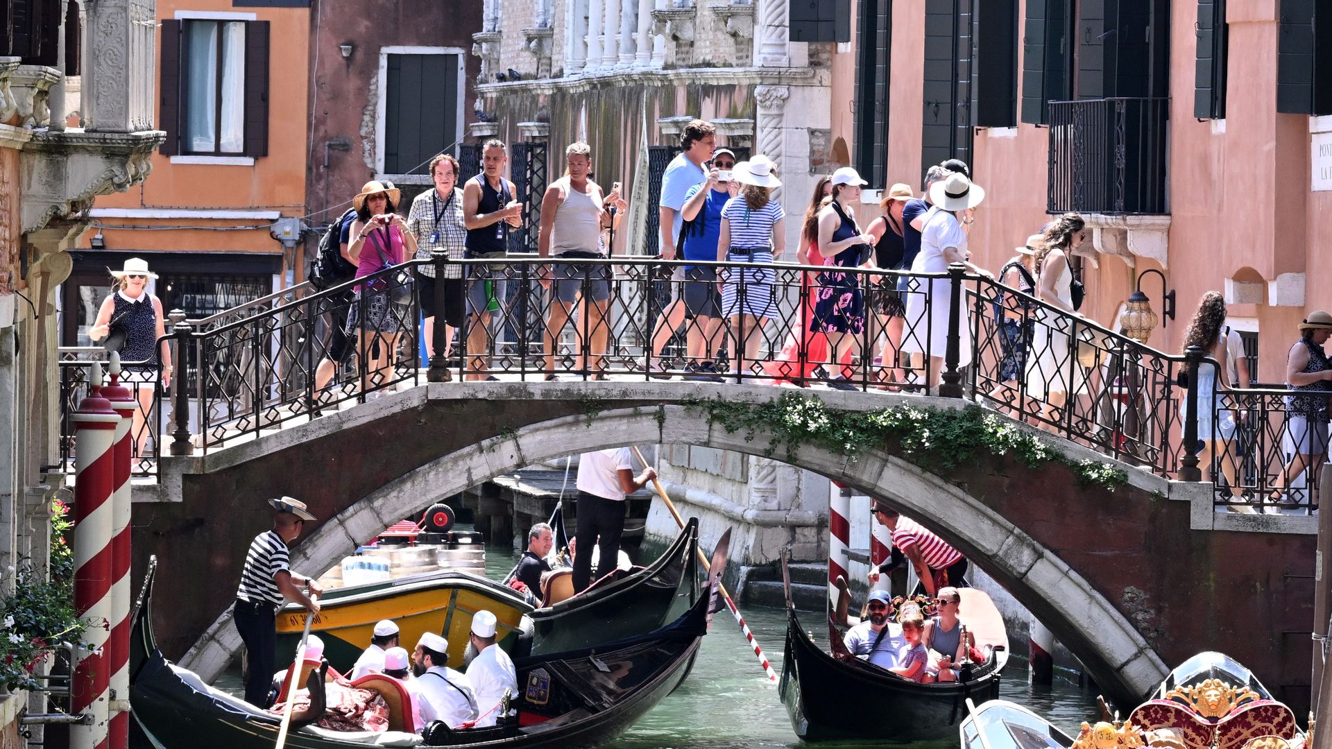 Tourists are seen sightseeing by gondola in Venice, Italy, July 18