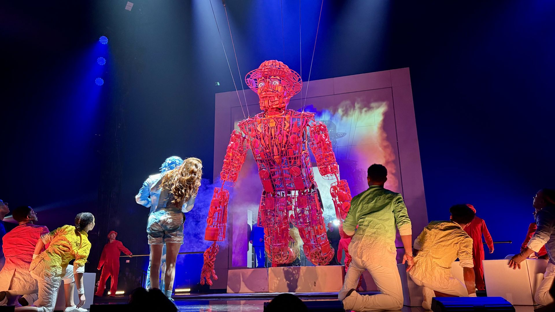 The puppet emerges from the cube. It doesn't blink, but its eyes do move.