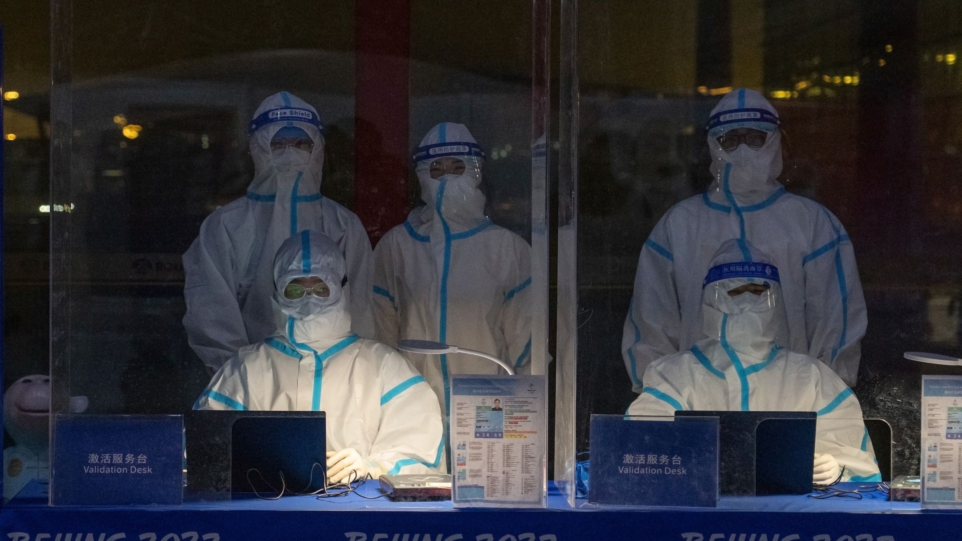 Testers in hazmat suits at Beijing Airport
