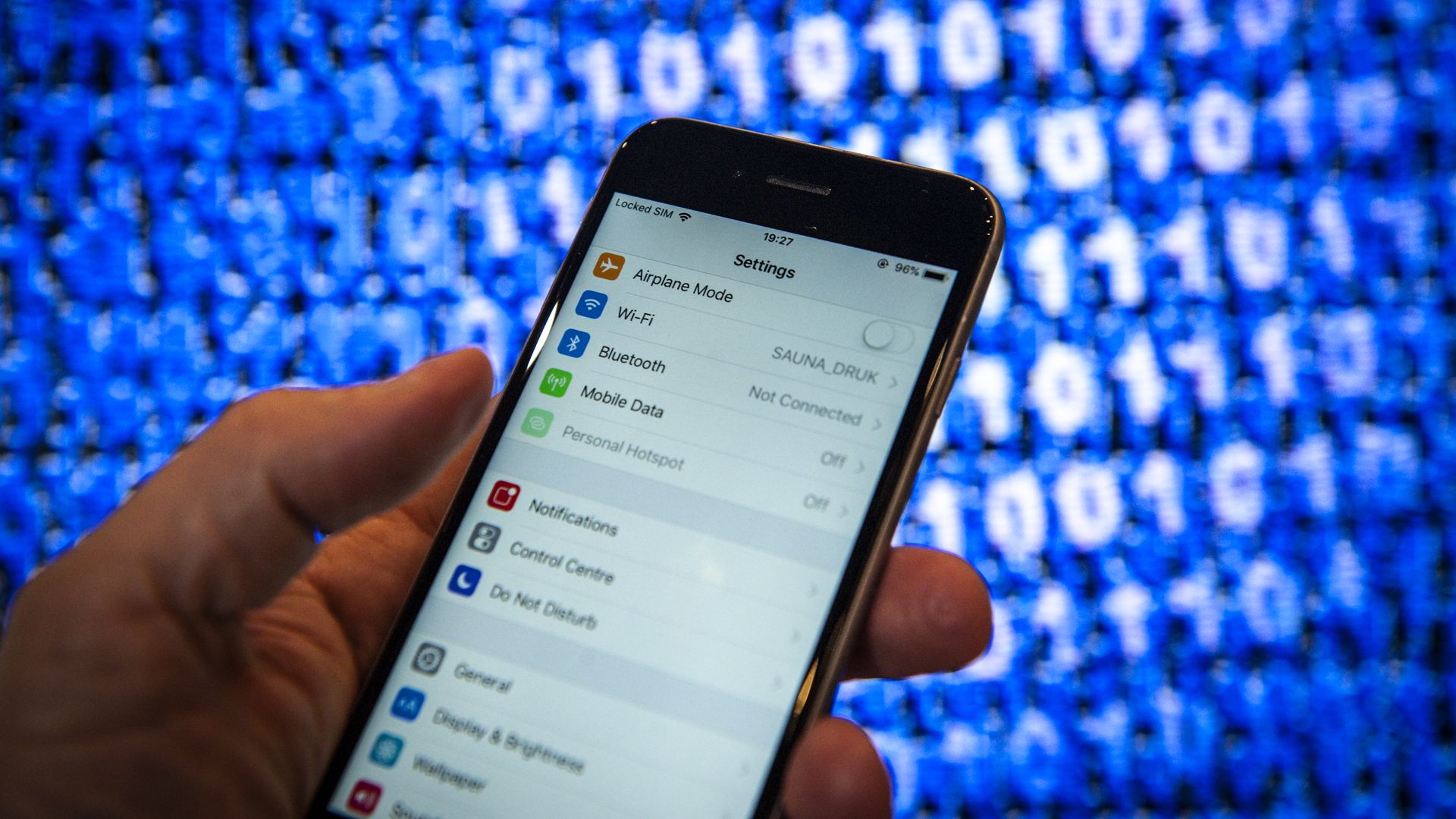 A hand holding a cell phone