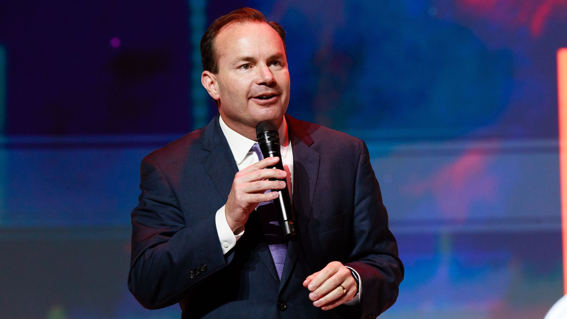 Sen. Mike Lee speaking with a microphone.